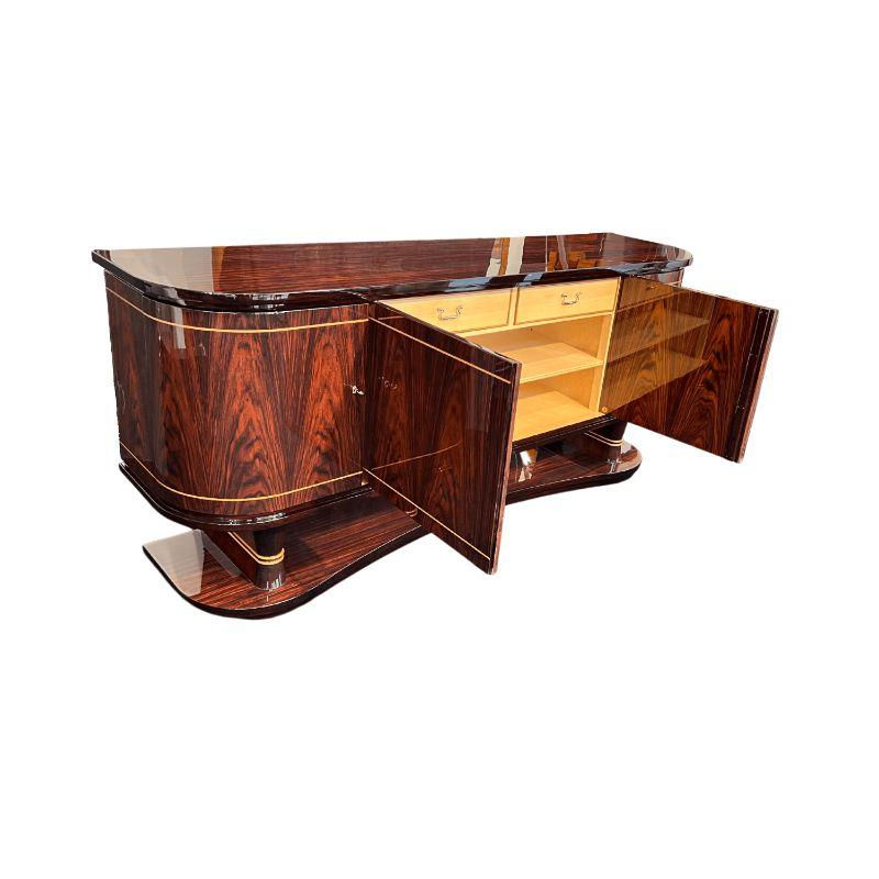 Extraordinary high-quality Art Deco sideboard or buffet, probably from Belgium about 1930.

Rosewood veneered with maple band inlays. Completely restored and varnished with piano lacquer high gloss. Standing on 2 legs and long veneered