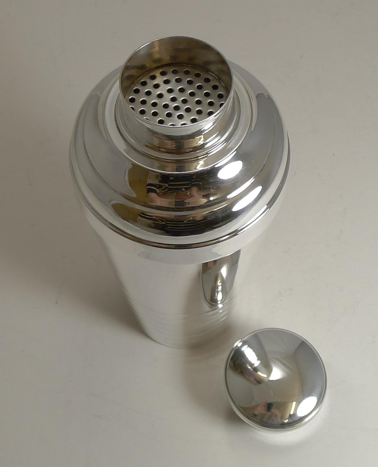 An impressive large Art Deco cocktail shaker, French in origin dating to circa 1930.

Just back from our silversmith, it has been professionally cleaned and polished to it's former glory.

The underside is signed by the silversmith as per the