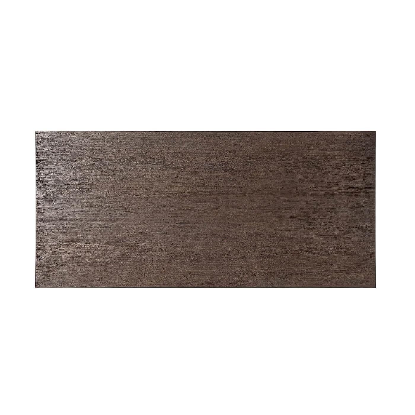 A large Art Deco style coffee table with a cardamon finish lati veneered top resting on brushed brass finish legs with interior faceting. This piece has a chic, clean-lined design with a beautiful balance of wood tones and brass finish metal