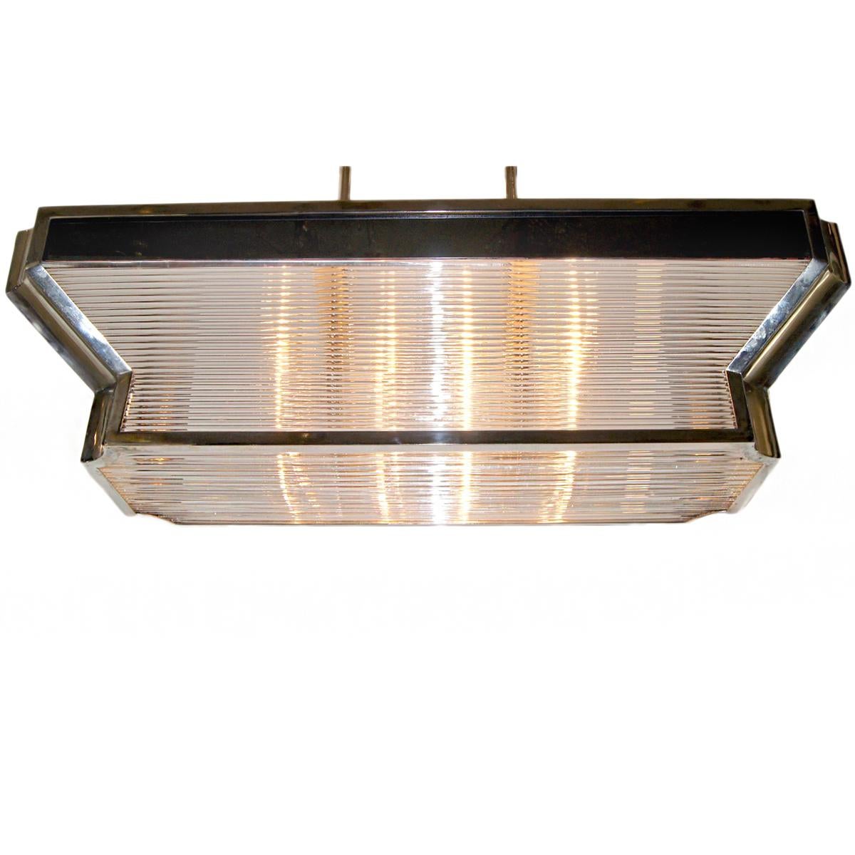 A circa 1950's French Art Deco style chrome and glass rods light fixture with 8 interior lights.

Measurements:
Drop: 26