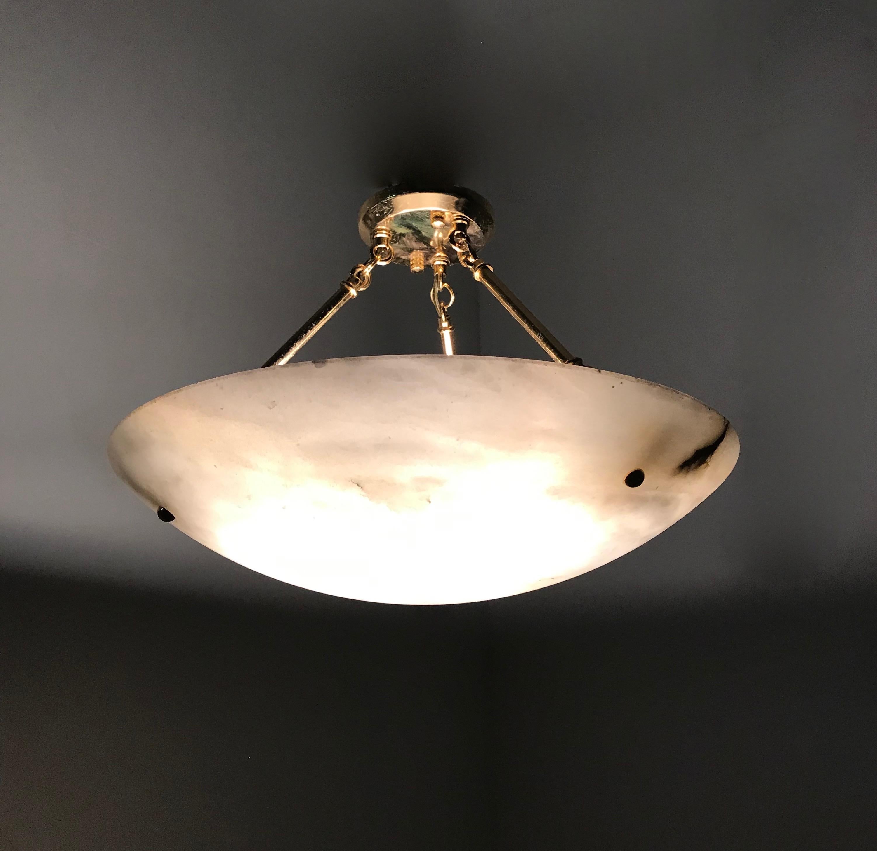 Excellent condition, Italian Art Deco style 3-light pendant.

If you like Art Deco chandeliers and pendants, but you would rather have them look like new then this 1970s alabaster shade and brass chains light fixture could be perfect for you. The