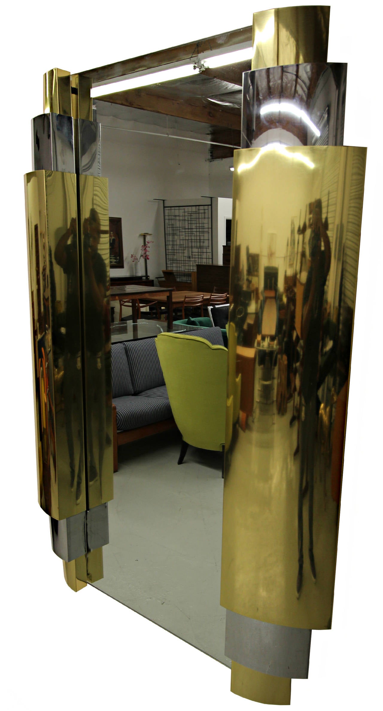 Absolutely stunning and very large Art Deco style tiered chrome and brass mirror by Curtis Jere. Signed and dated 1985.

Mirror is in overall good condition showing minimal signs of wear from age and use.