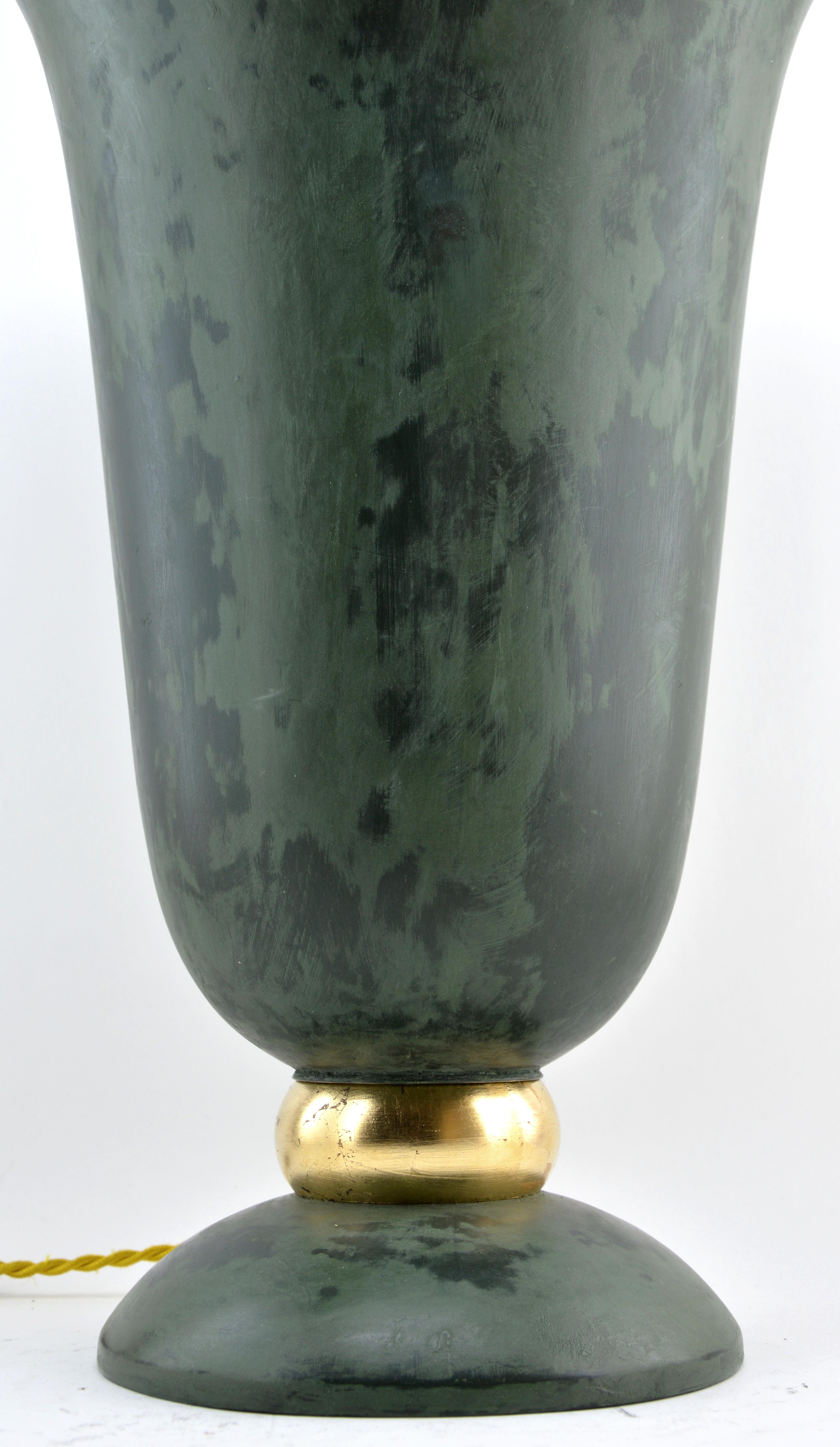 This large French Art Deco table cornet lamp, crafted in France in the 1920s, showcases a stunning design with a copper construction featuring a bronze green patina on the exterior and a beautifully painted interior. The lamp’s elegant ring is gilt