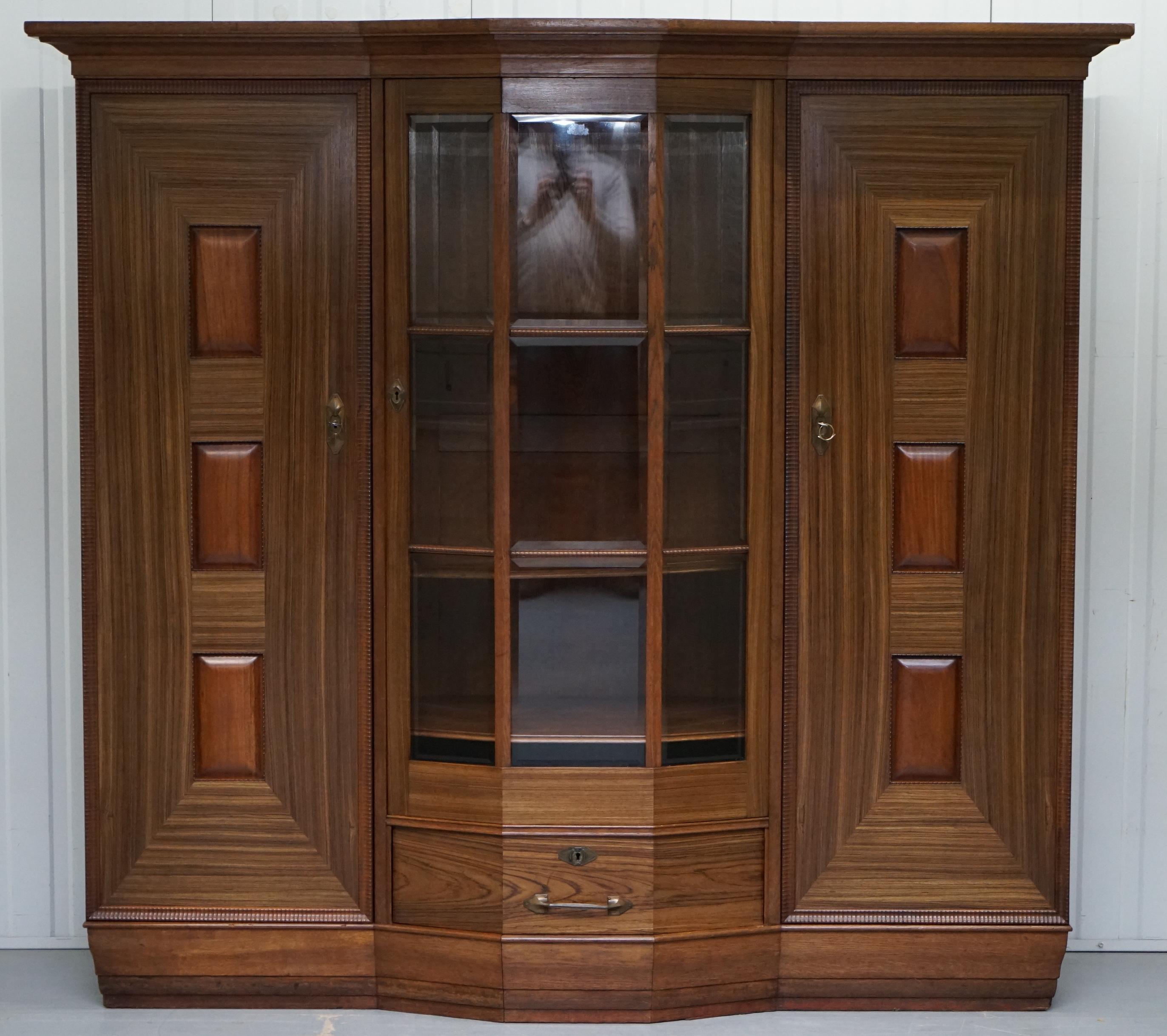 We are delighted to offer for sale this large Art Deco teak veneer and other tropical wood Library break front bookcase cupboard

A very substantial piece of furniture, the middle door is break front so comes out from the frame, it has the