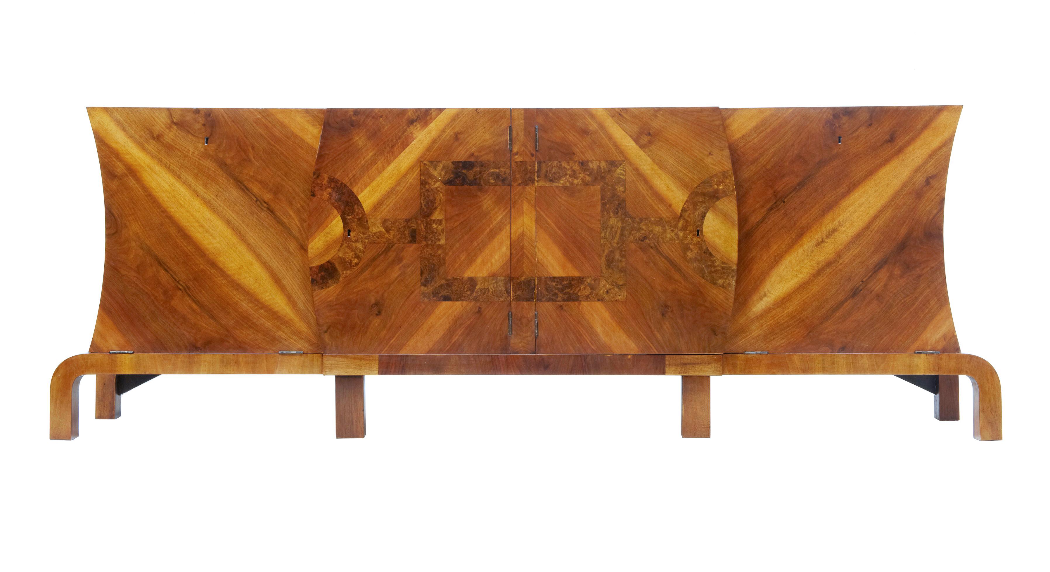 Large Art Deco walnut and burr inlaid sideboard, circa 1930.

Imposing Art Deco sideboard of large proportions, circa 1930. Beautiful veneered in walnut and beautifully crossbanded in burr walnut. 2 central doors that open to a single shelf in