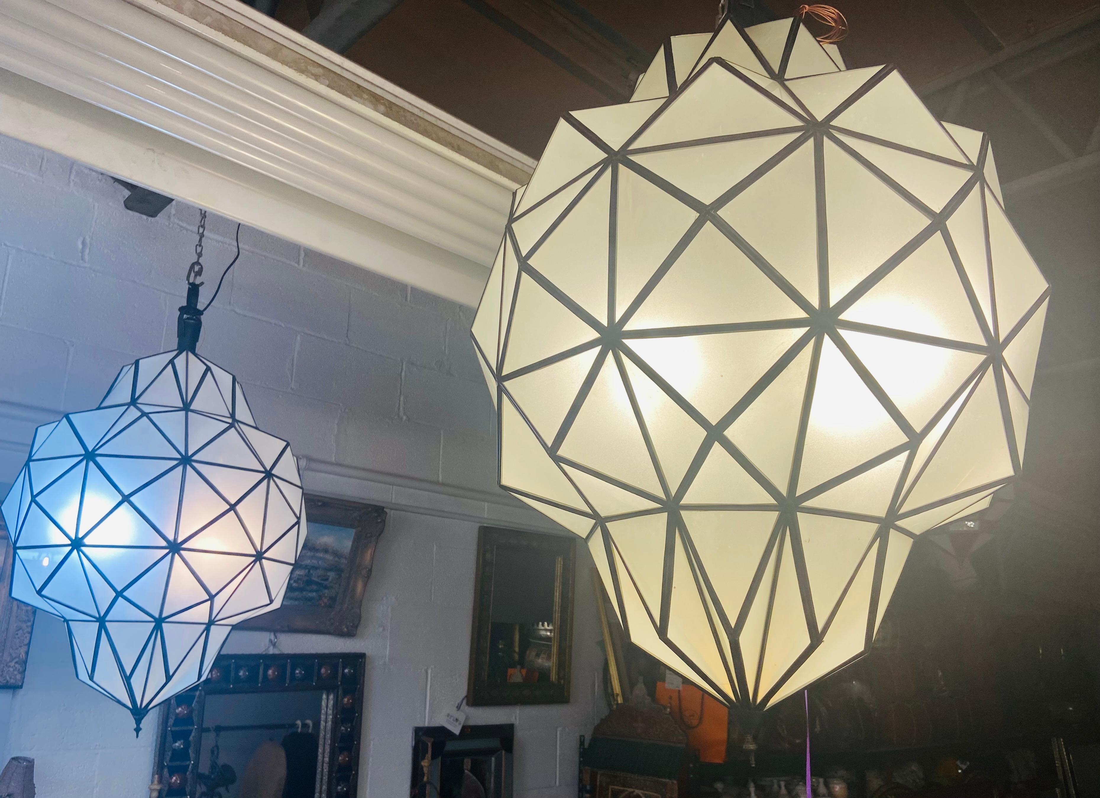Large Art Deco while milk chandelier, pendant or lantern in dome shape, a pair
A stunning pair of Art Deco style dome form milk glass white chandeliers or lanterns. Each having individual panes, possessing an open door pane leading to a double