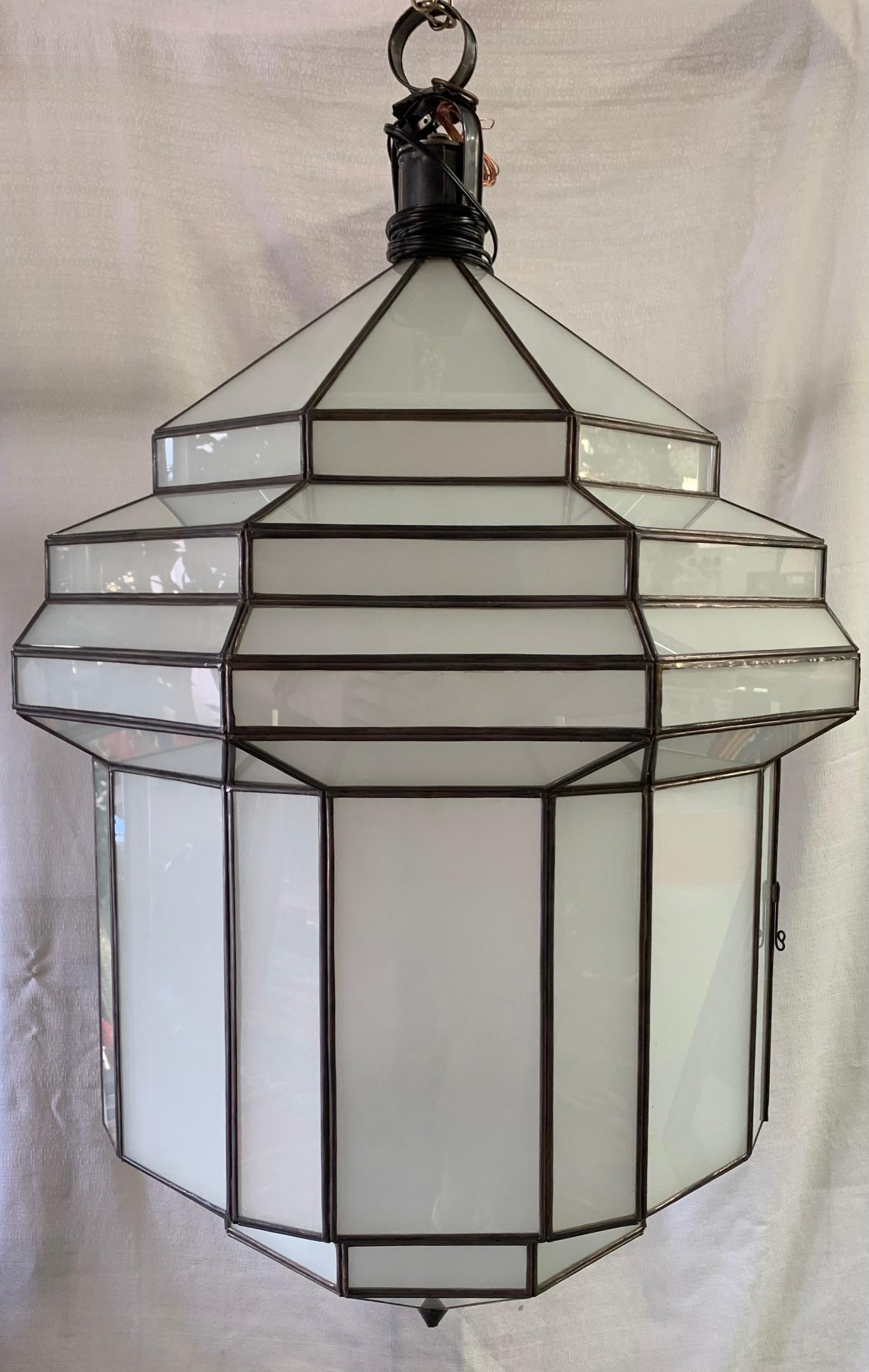 Large Art Deco white milk glass handmade chandelier, pendant, lantern, a pair

A gorgeous handcrafted, having individual panes, pair of large Art Deco hanging lanterns or ceiling fixtures featuring sandblasted frosted milky glass and patinated