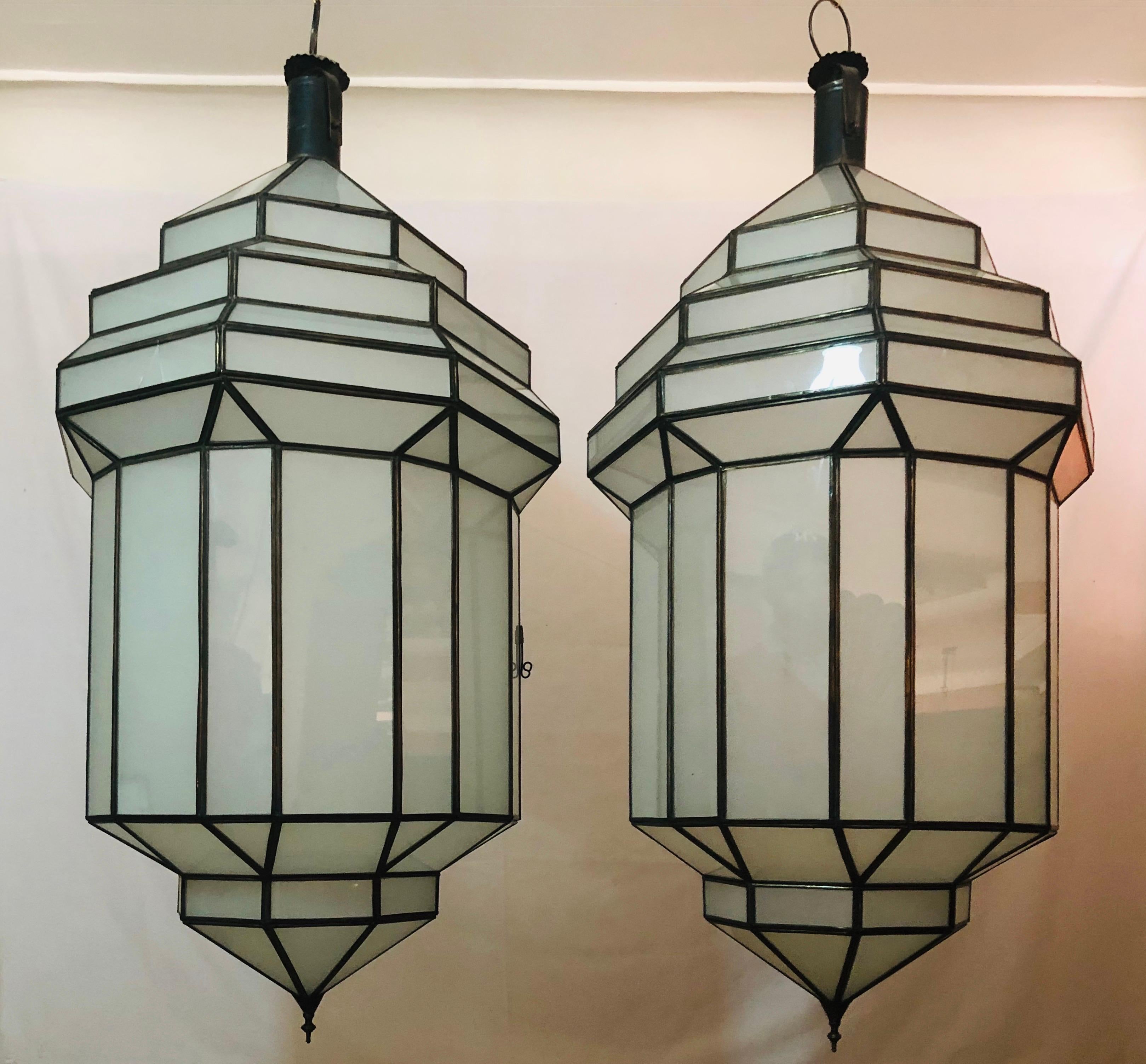 Large Art Deco White Milk Glass Handmade Chandelier, Pendant, Lantern, a Pair
A gorgeous handcrafted, having individual panes, pair of large Art Deco hanging lanterns or ceiling fixtures featuring sandblasted frosted milky glass and patinated metal