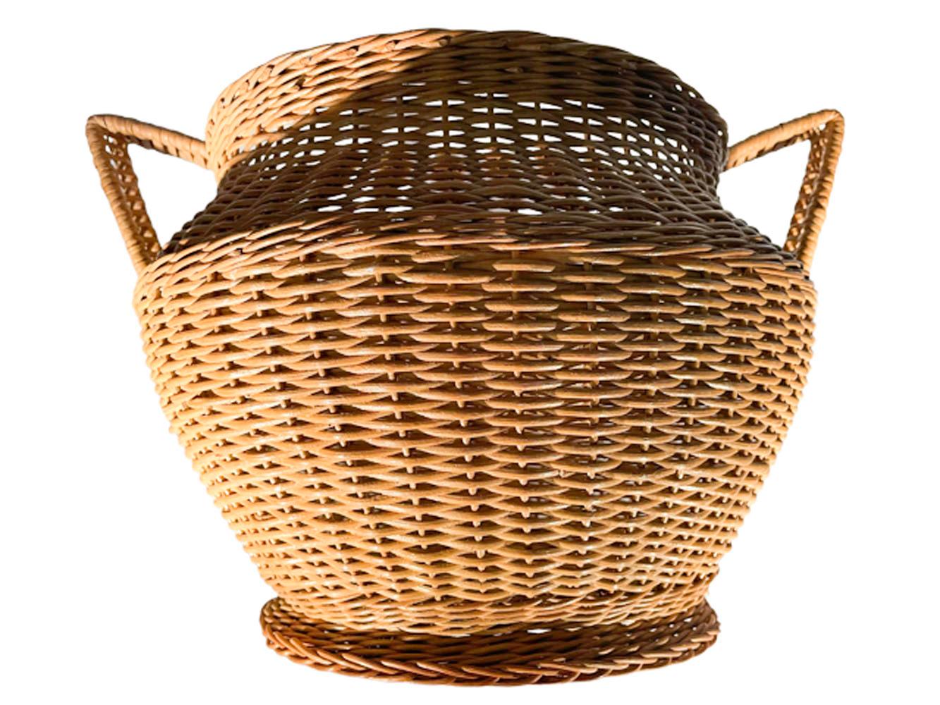 Large Art Deco wicker cachepot / planter with angular handles connecting to the rim and shoulder in pale natural color cane and retaining its original Haywood-Wakefield label. Excellent condition.
Overall:
11.5