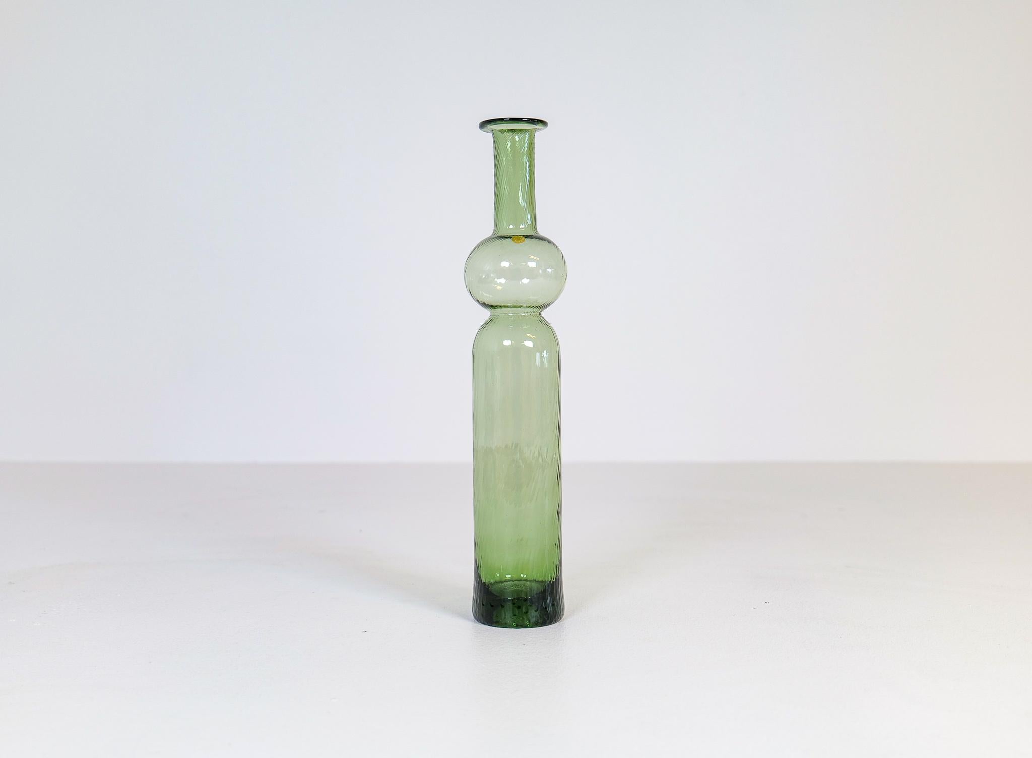 This large art glass bottle is handmade at Riihimäen Lasi Finland and designed by Nanny Still. The name of this green twined bottle is Neptuna.

Good condition

Measures: H 34 cm.
 