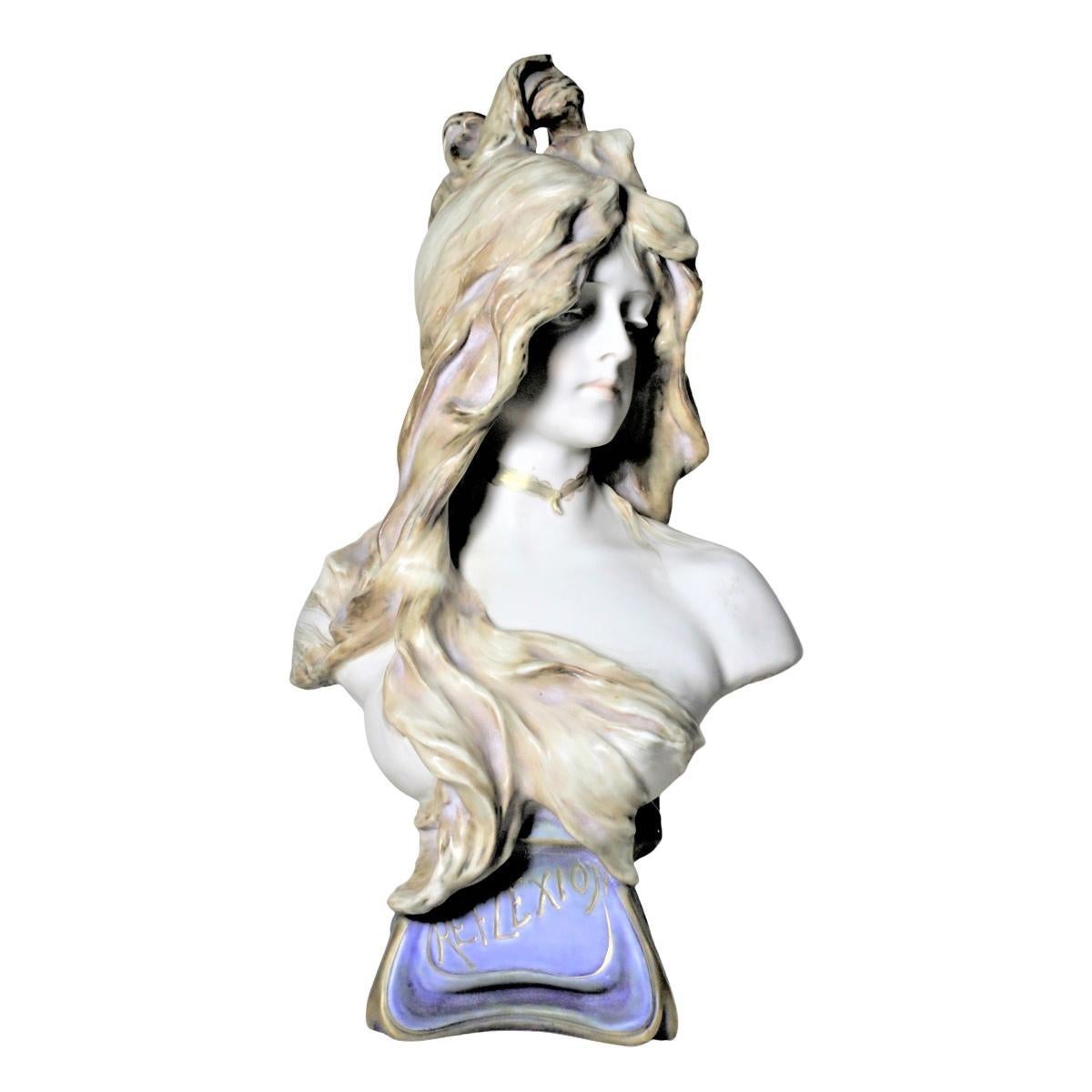 This monumental Art Nouveau porcelain bust of a young beautiful maiden was produced by the Riessner, Stellmacher & Kessel (RStK) factory of Teplitz, Bohemia in about 1902. The bust depicts a young female in contemplation and is entitled 