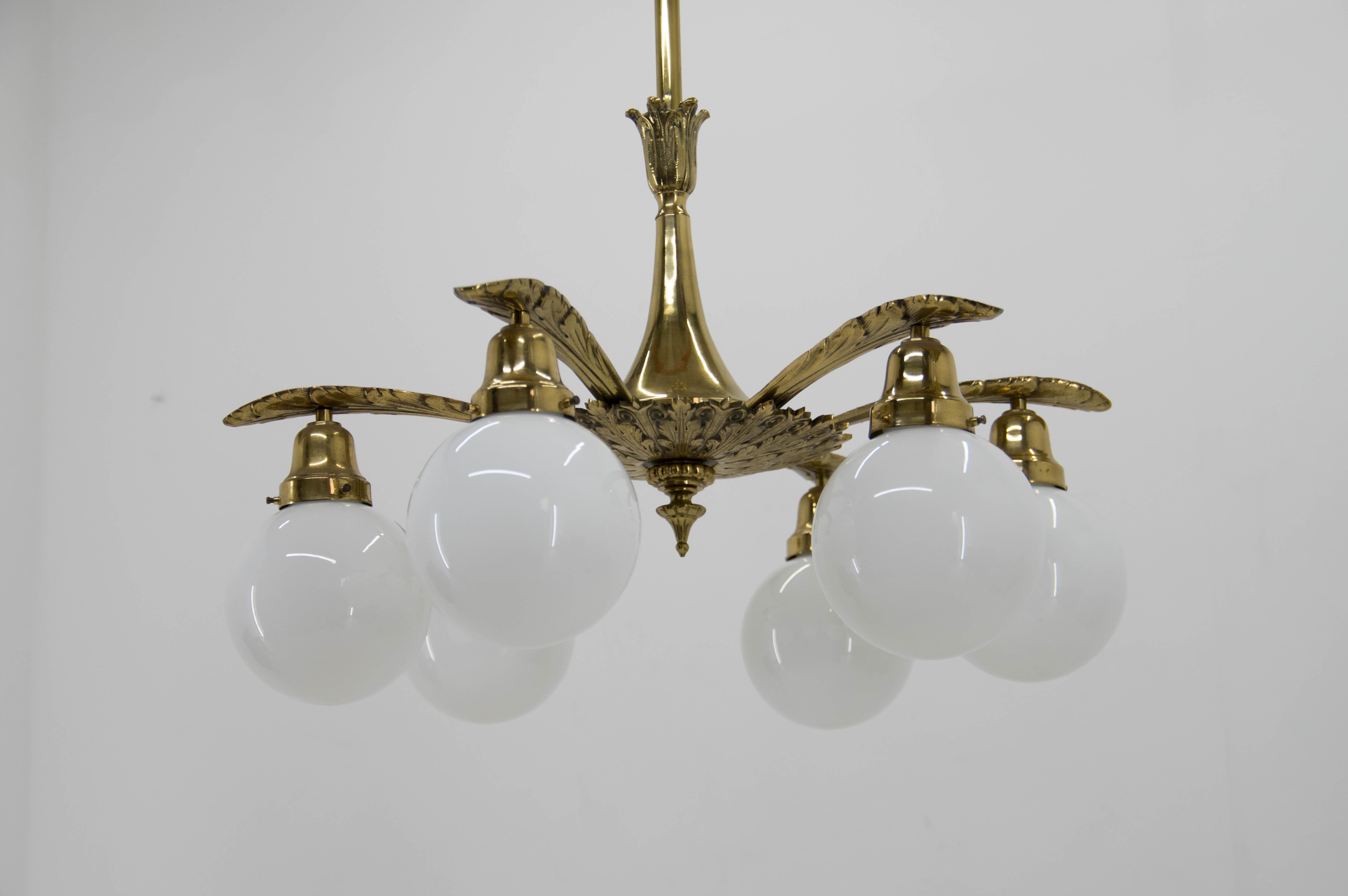 Large and heavy Art Nouveau brass 6-flamming chandelier.
Restored, cleaned, rewired.
Opaline glass in perfect condition.
Central rod can be shortened on request.
Two separate circuits: 3+3x40W, E25-E27 bulbs with small head.
US wiring compatible.
 