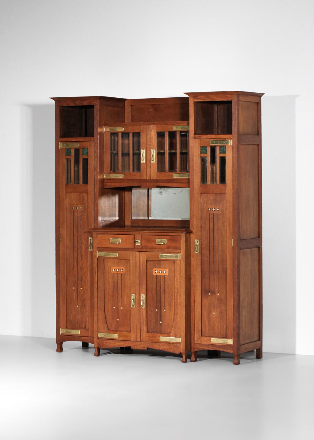 Imposing 1930s art nouveau buffet in the style of Gustave Serrurier Bovy. The sideboard is made up of four elements (which can be dismantled if required for shipping): the two large side columns, the lower sideboard and the upper glass shelf. The