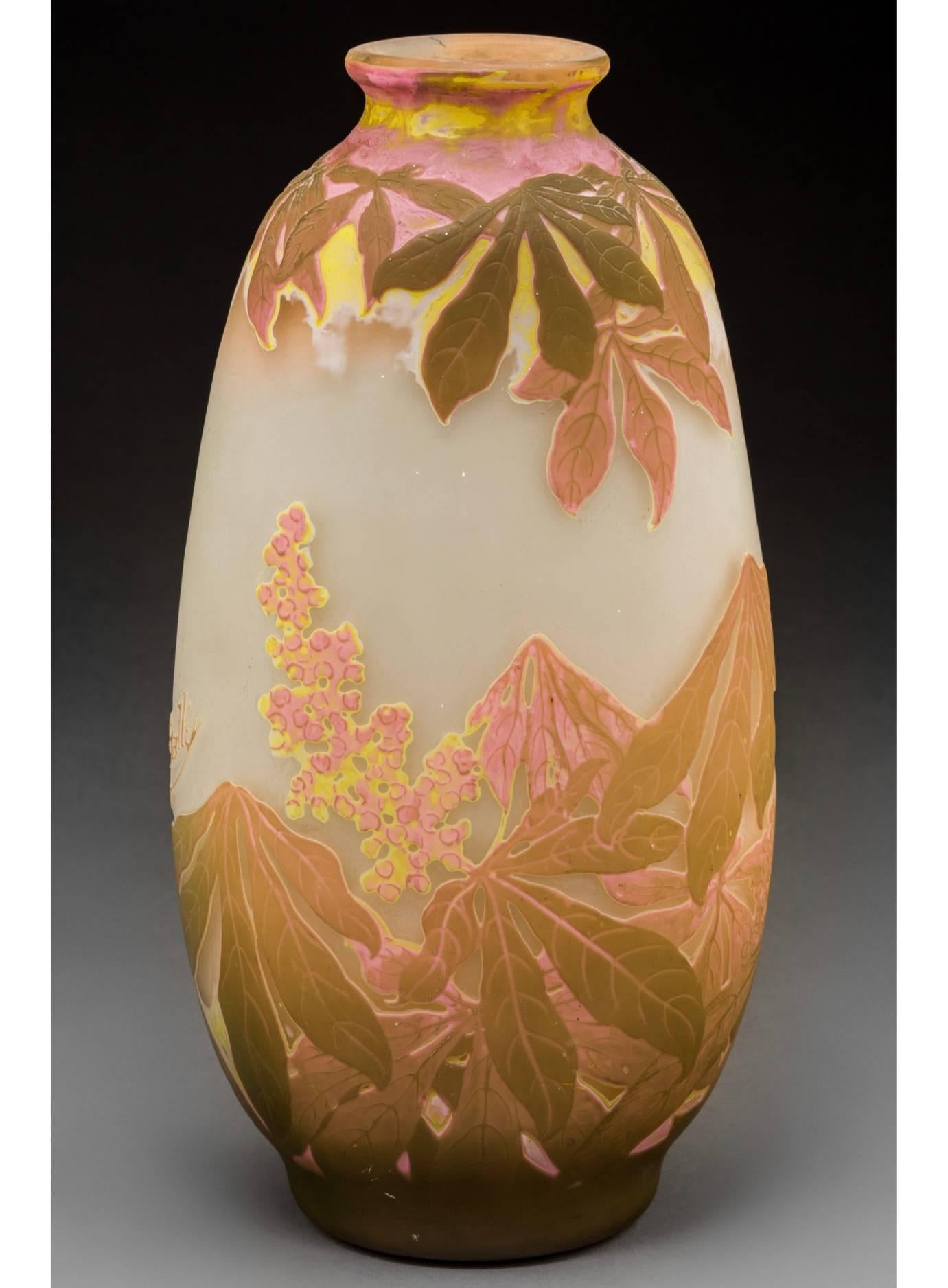 A stunning four color wheel carved and acid etched fat vase with pink, yellow, greenish browns and white on a cream background. The coloring is strong and the workmanship excellent. A truly explosive expression of flowering and seeding botanicals.