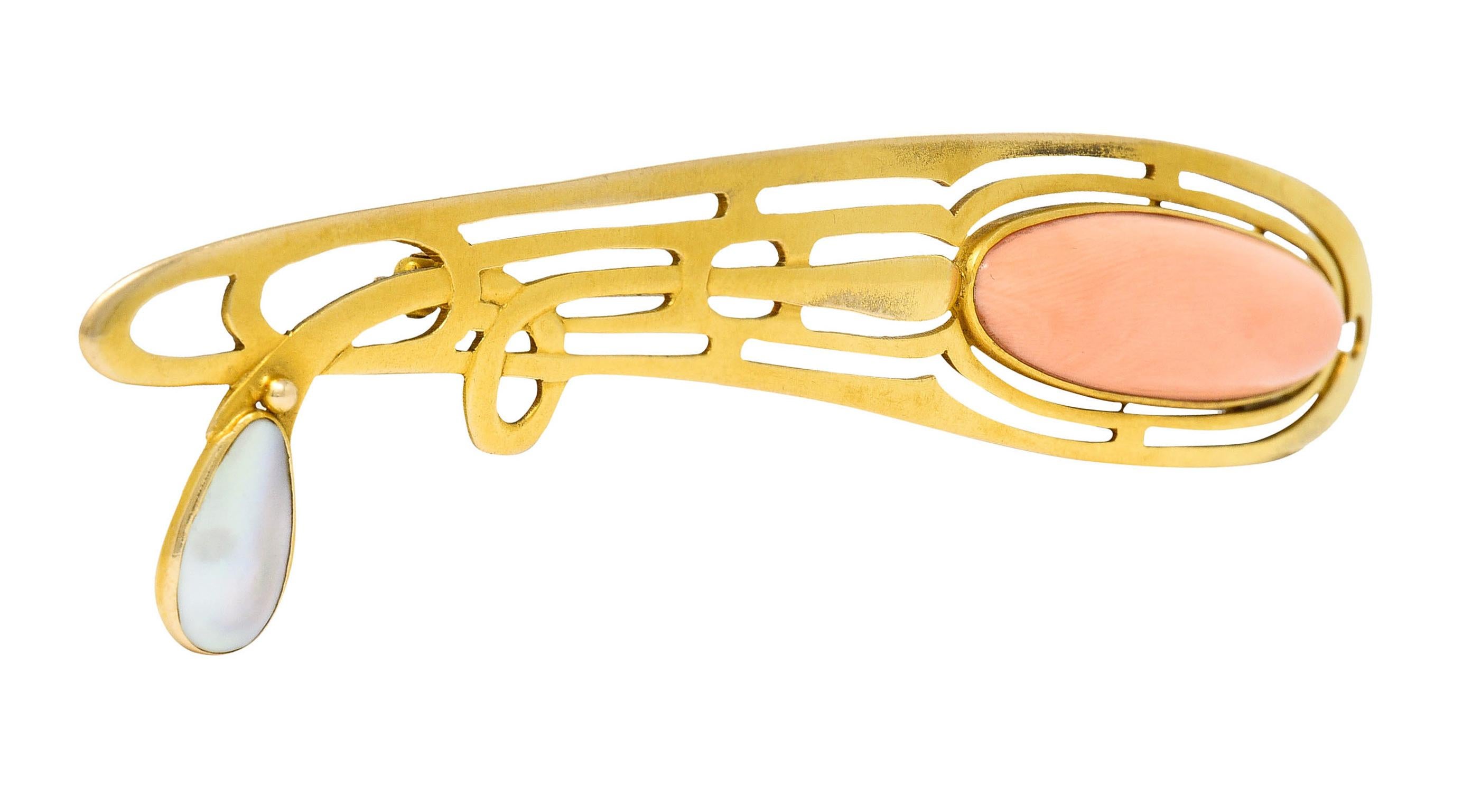 Substantial brooch is a stylized whiplash design

Featuring an elongated oval cabochon of pastel peachy pink coral

Measuring approximately 45.5 x 11.5 mm and exhibits moderately swirling color distribution

With a pear shaped blister pearl - white