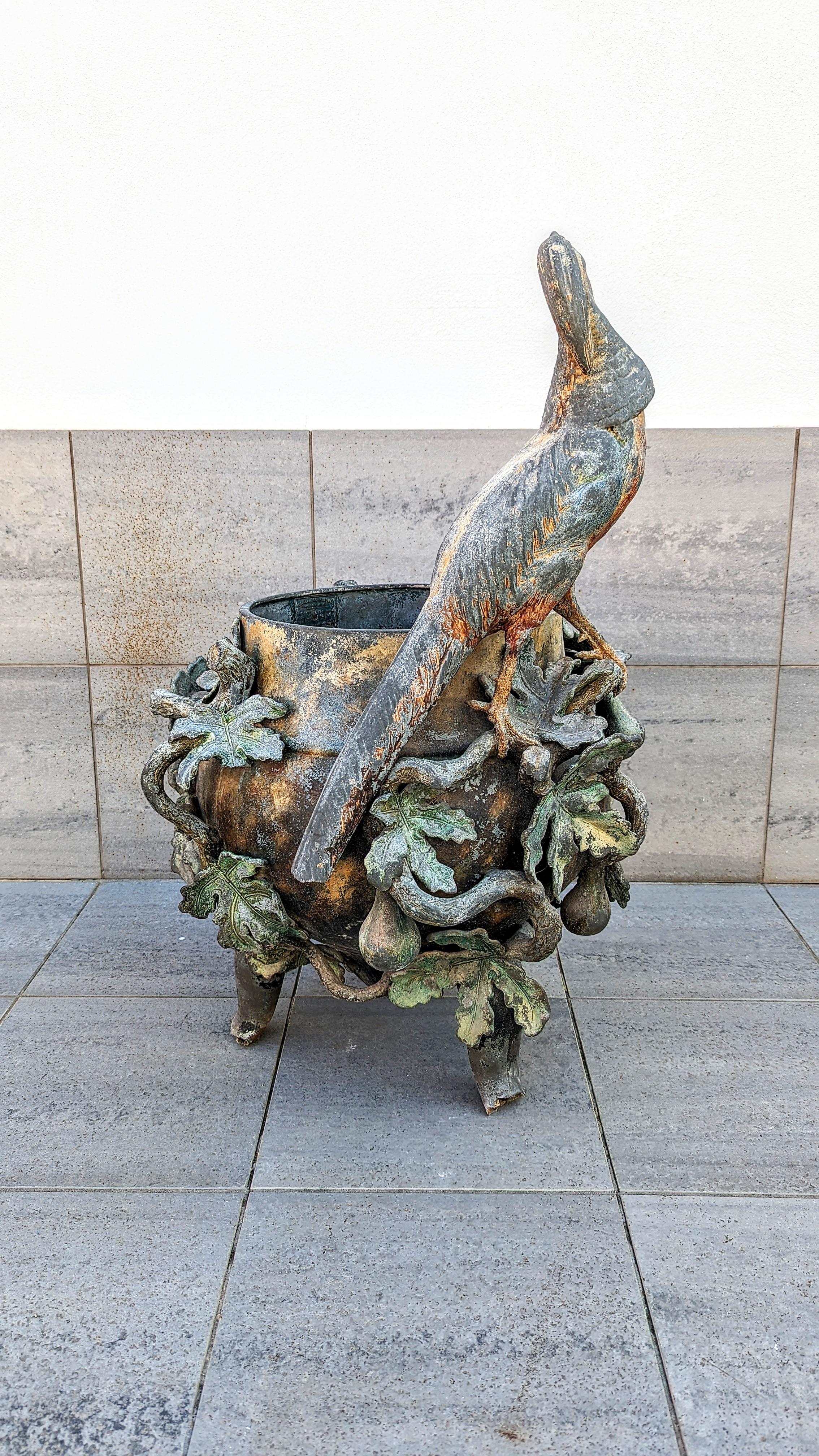 Incredible piece and work for this very large Art Nouveau painted iron cast planter, manufactured in France by Metallo ceramique LH in 1920s.
An elegant pheasant towers over this gorgeous planter or vase, with an amazing fig tree branch ornaments
