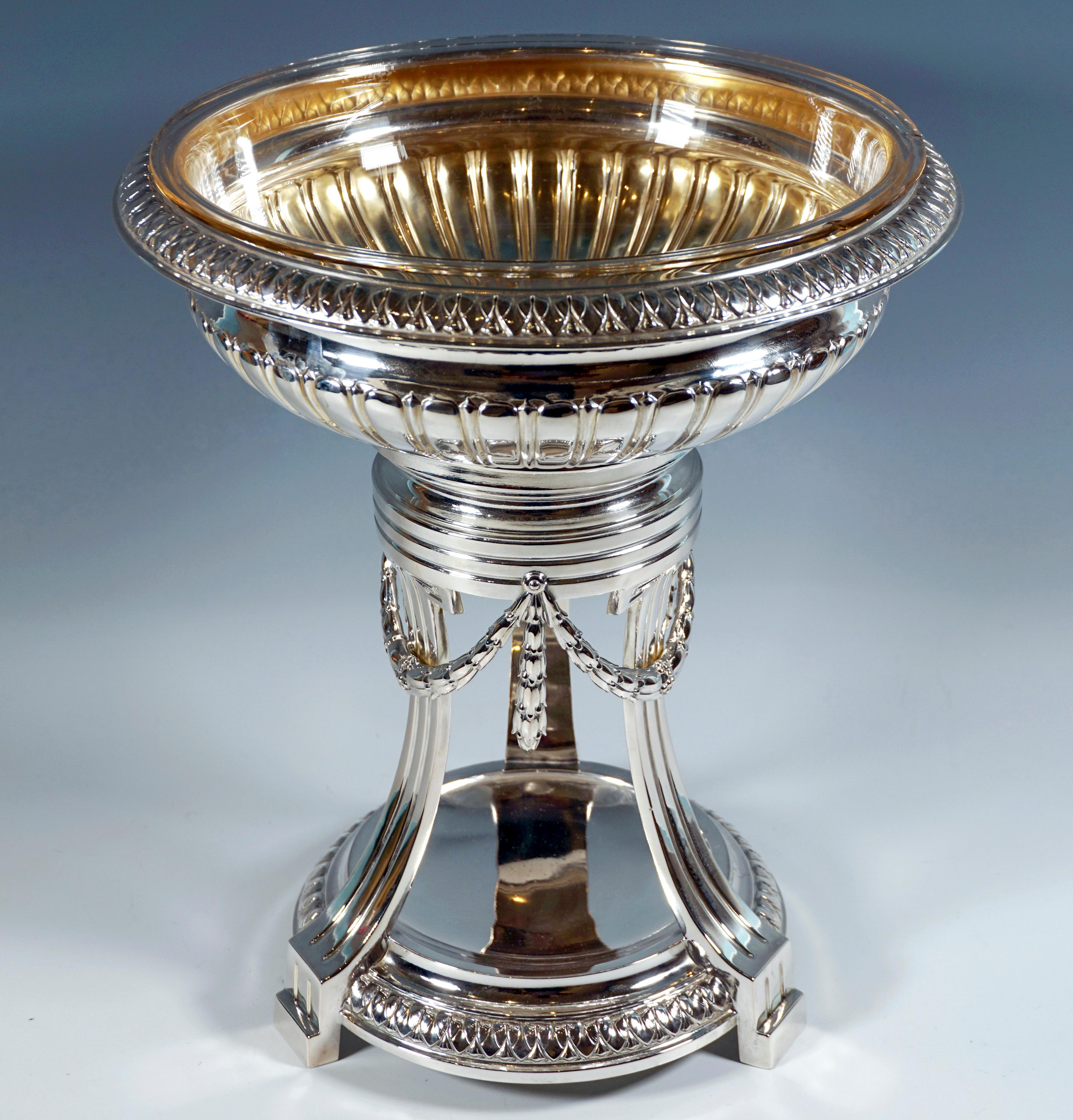Festive Art Nouveau silver centrepiece on a high stand, round, stepped fluted base plate, framed by a stylized palmette frieze, supported just above the base by three raised, inwardly curved, upwardly tapering, vertically profiled pilasters,