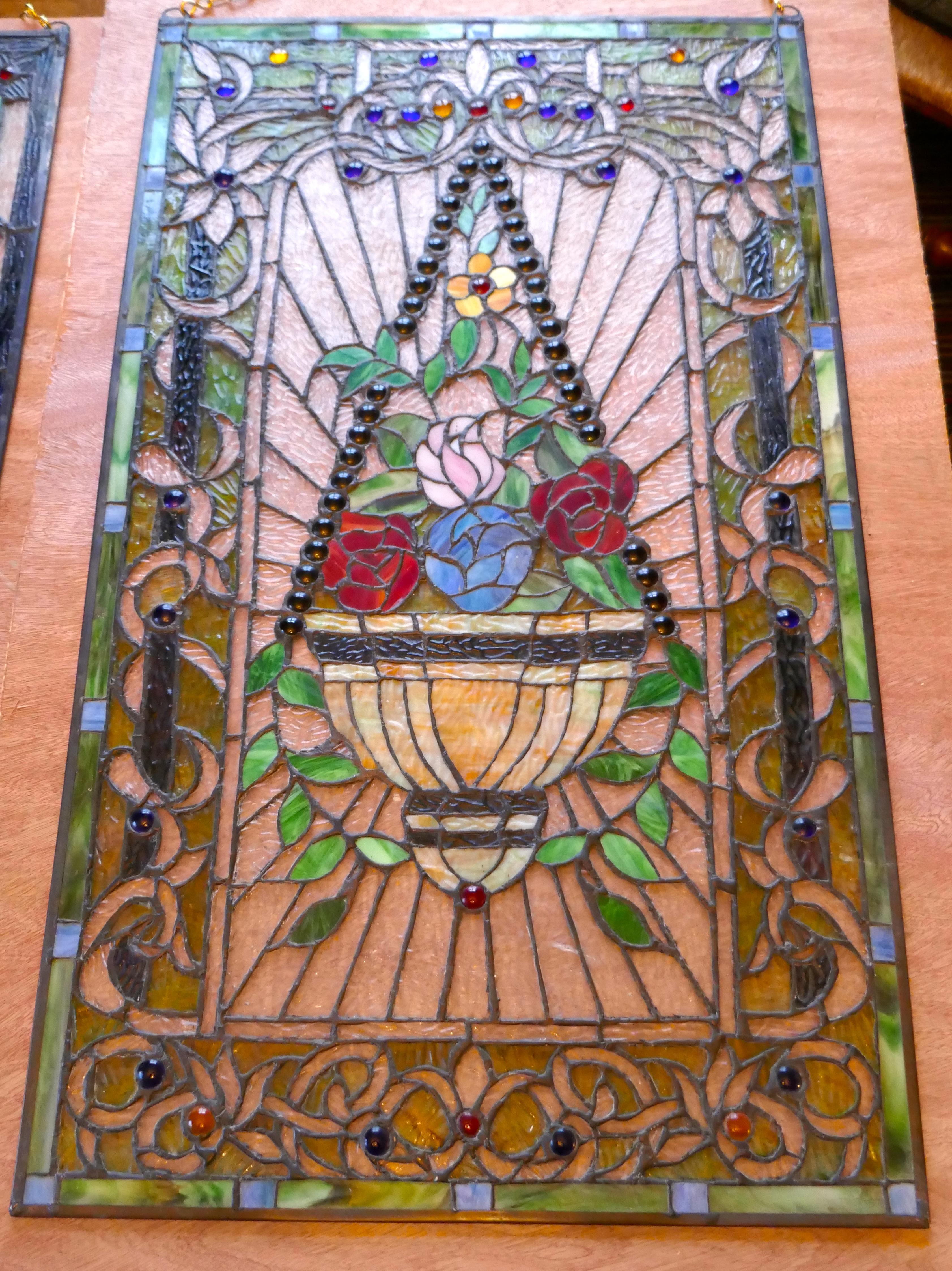 Large Art Nouveau Stained Glass Panel for a Window or Door

This is a 19th Century piece, it has very attractive fine lead work outlining the stunning Jewelled Glass
The Design of the panel depicts a hanging plant container filled with roses
The