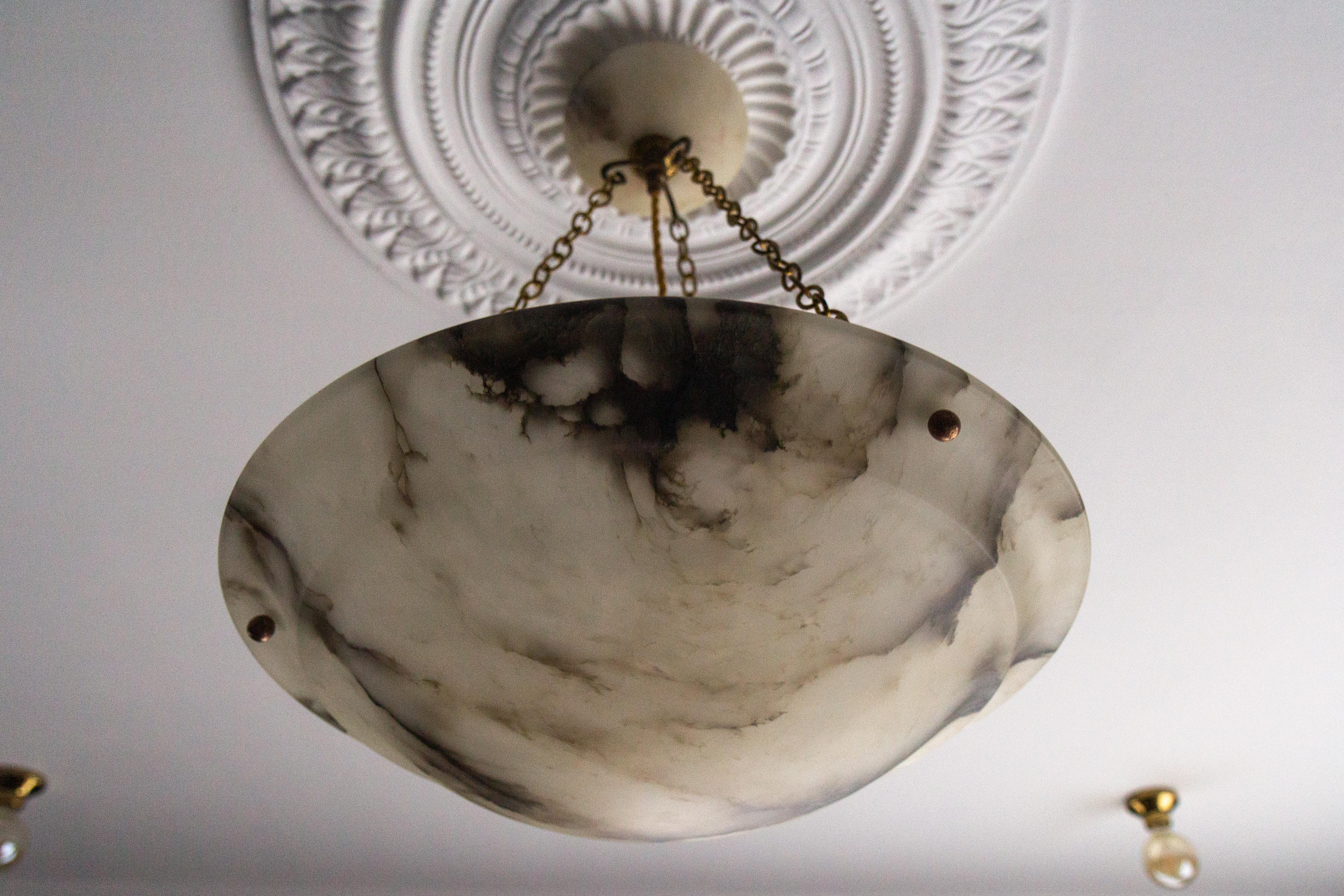Antique large French Art Nouveau black veined white alabaster pendant light fixture.
Gorgeous and beautifully shaped alabaster pendant ceiling light fixture from circa 1920. Superbly veined and masterfully carved white alabaster bowl suspended by