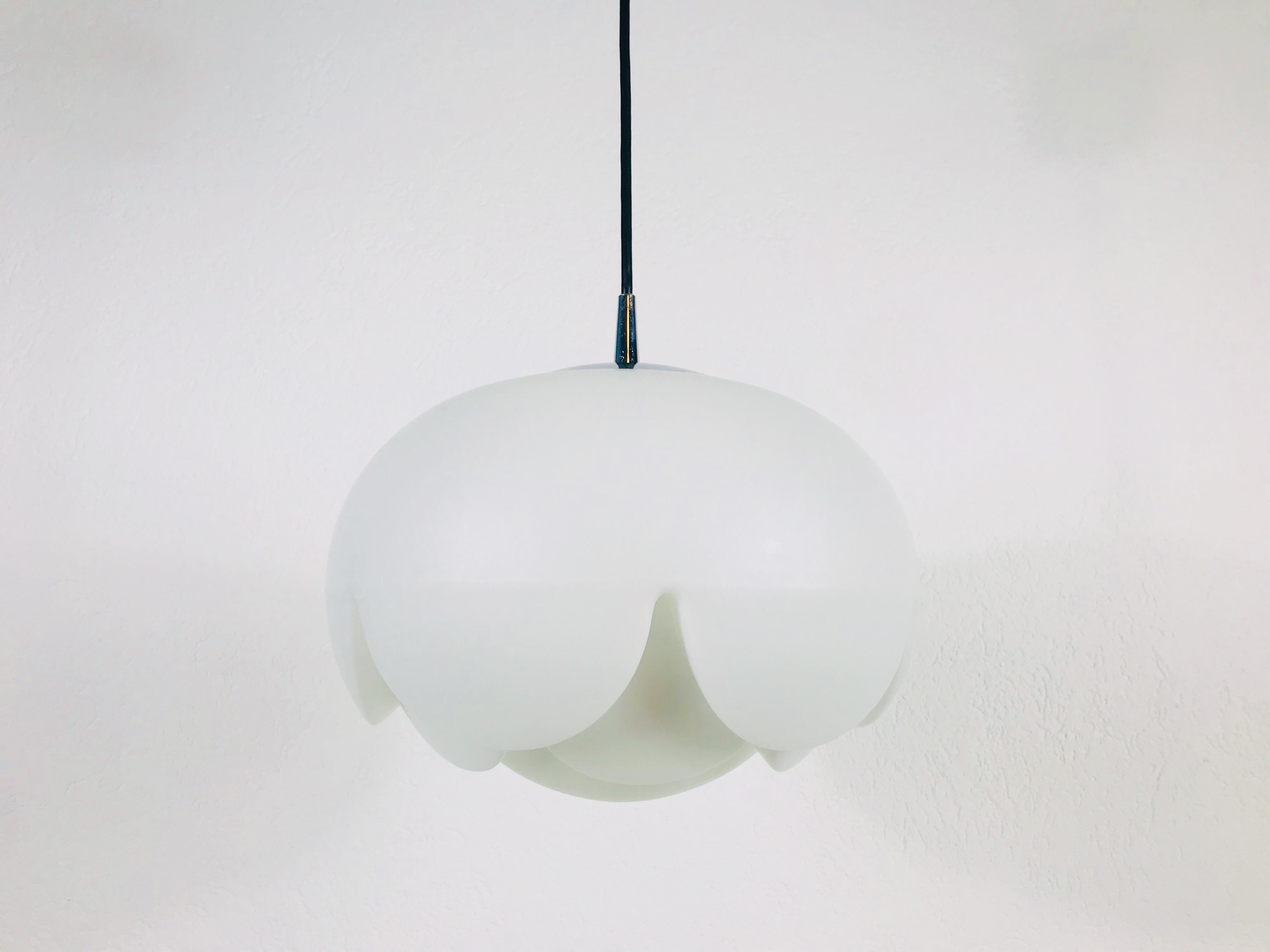 A Peill and Putzler hanging lamp made in Germany in the 1970s. It is fascinating with its glass ornaments. Textured opaline glass with aluminum top. The lamp has a beautiful artichoke shape.

The light requires one E27 light bulb.
