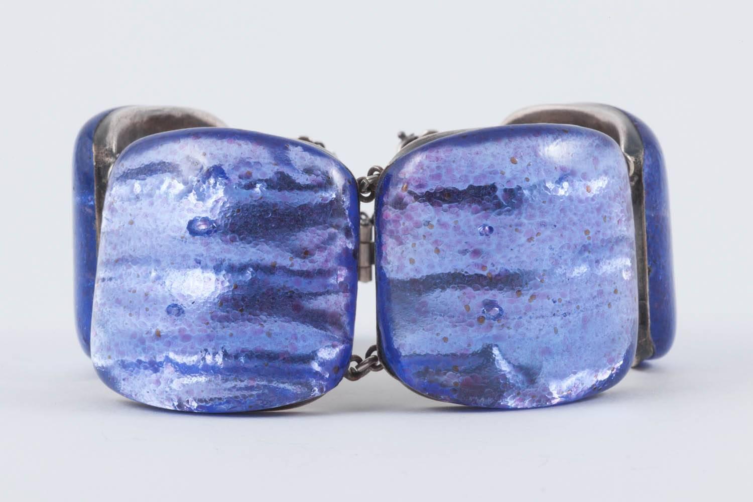 A stunning enamelled bracelet , handmade by Jacques Gautier, in a most striking and unusual colour, set in silver plated bronze, from the 1960s. With softly domed panels in a mirrored lilac enamel, with deep purple specks within the enamel, giving