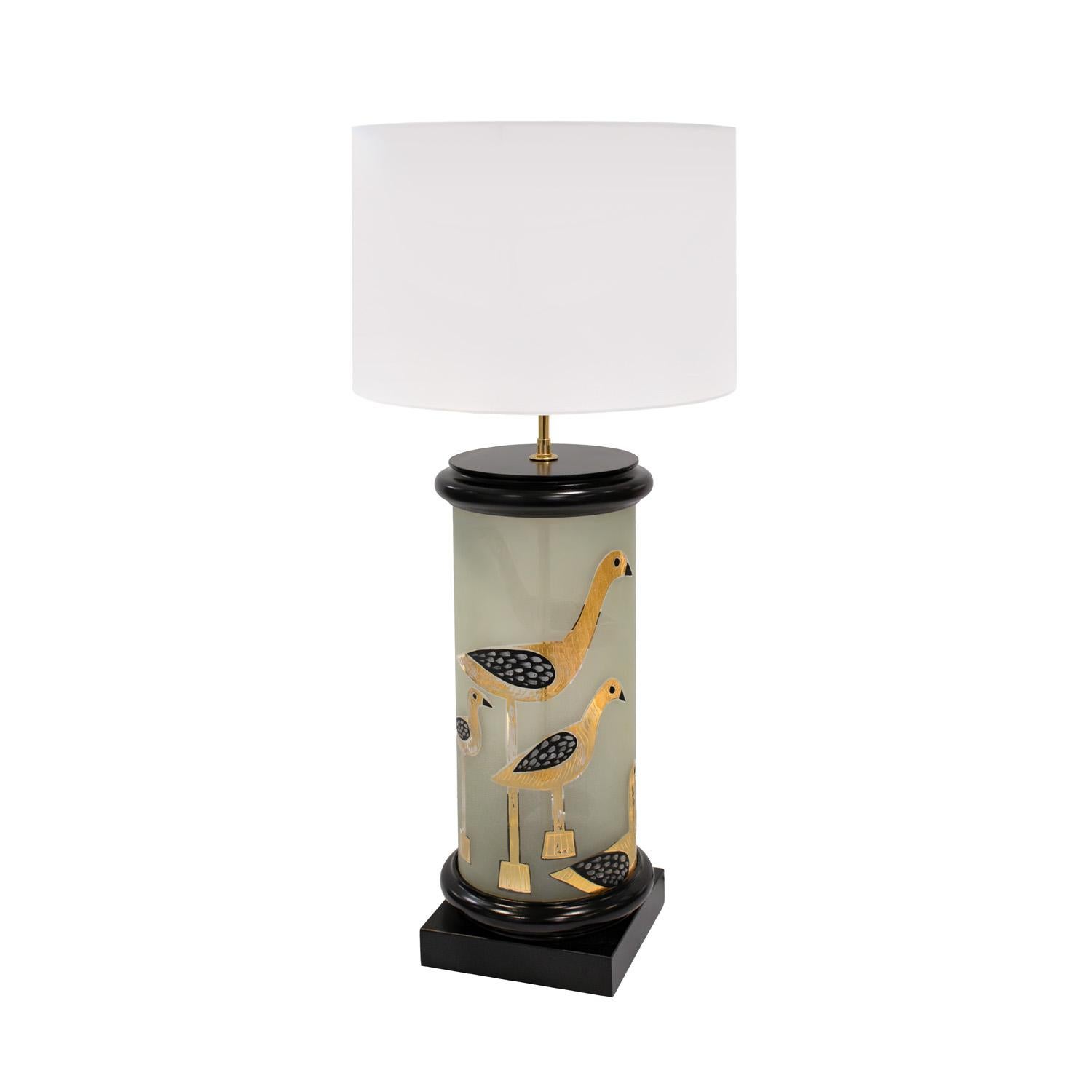 Large artisan table lamp in translucent glass with hand-painted bird motif in gold and black with ebonized wood base and top and brass hardware, American 1960's.  The scale and artistic design make this lamp a standout.  Ebonized base and top have