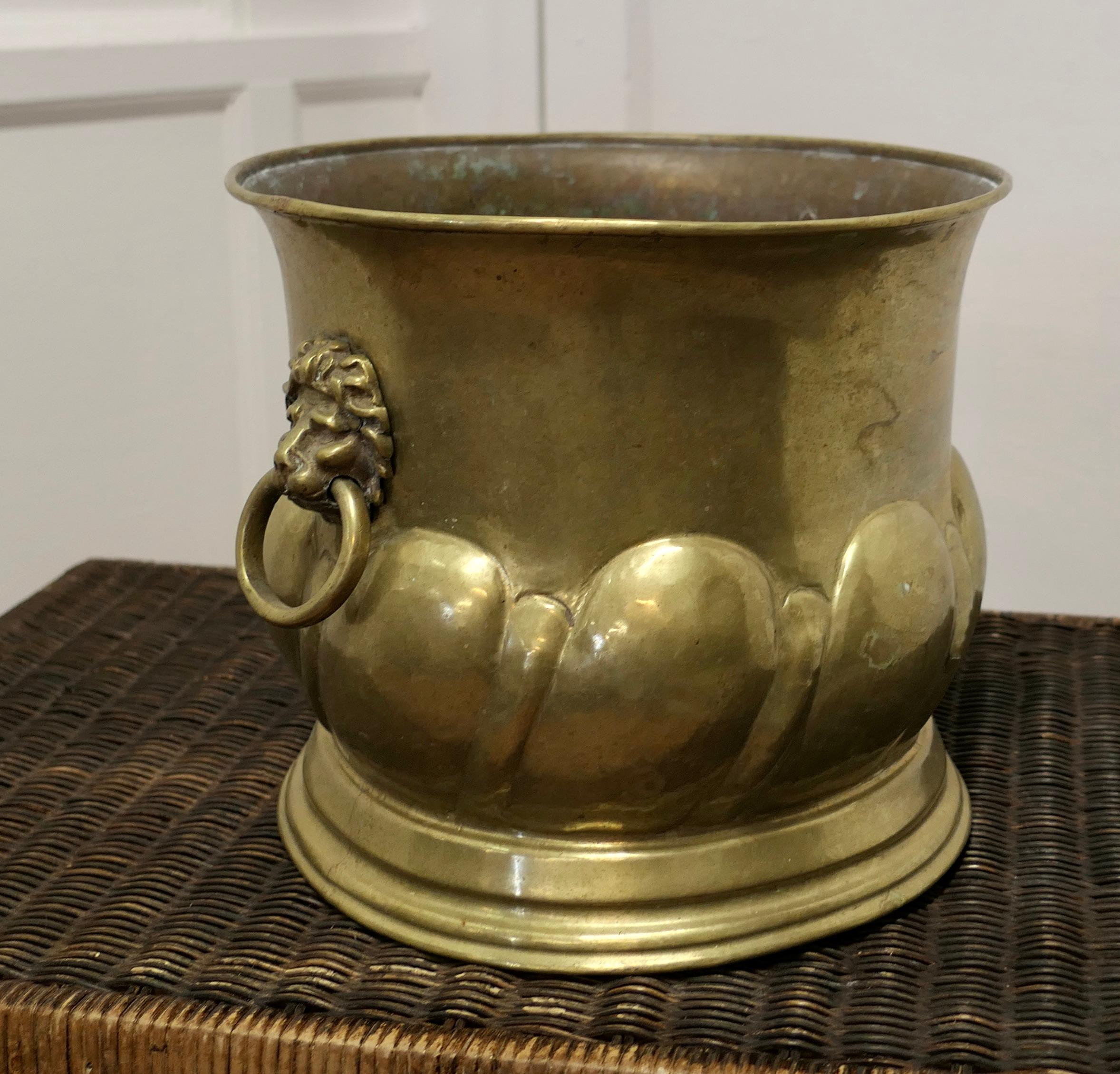 Large Arts and Crafts Brass Jardiniere with Lions Mask Handles

A large piece and a great looker
The pot is round and is made in brass with a beaten decoration and lions mask handles on each side
In good condition and large, the pot is 11” high