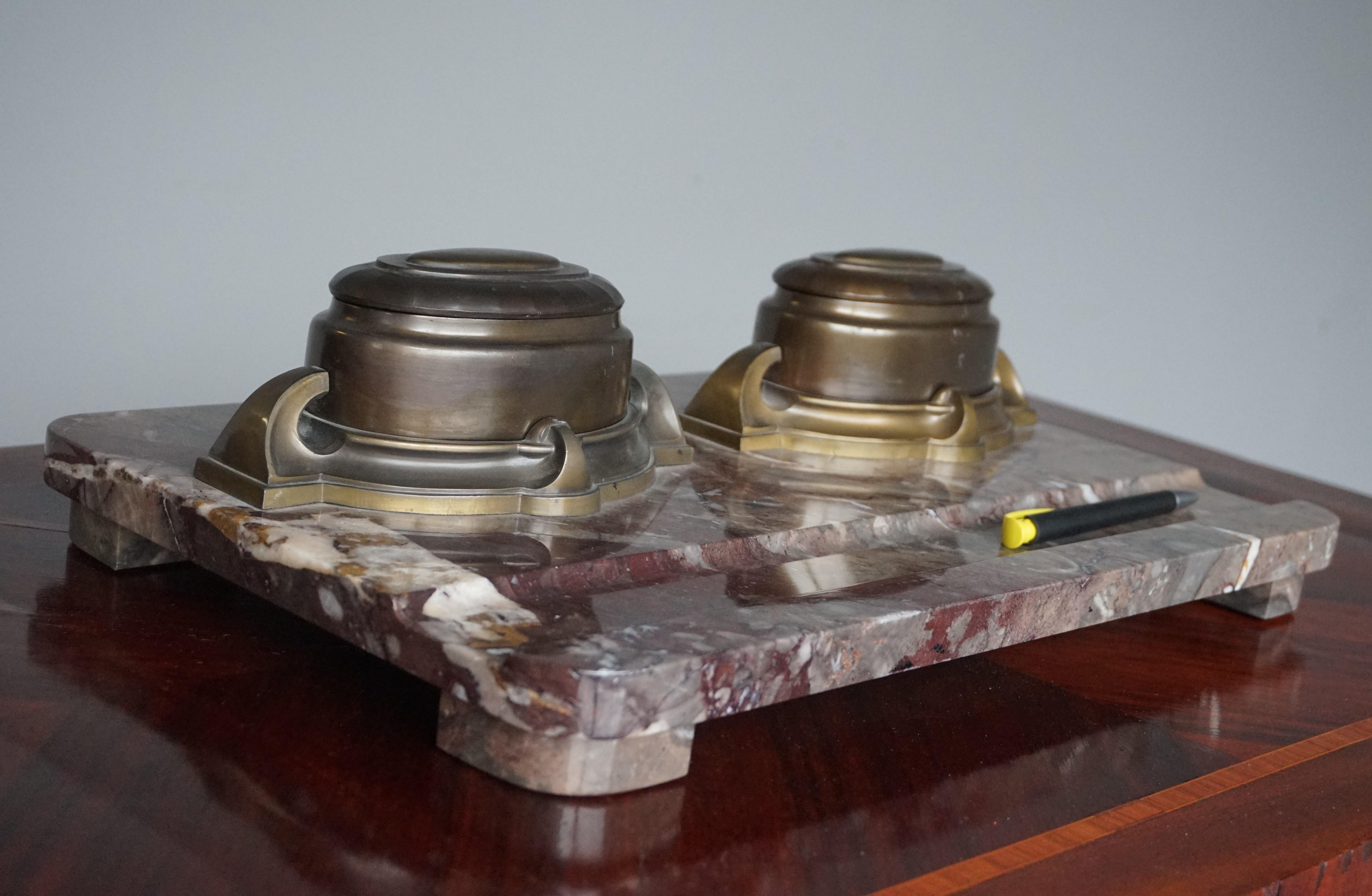 Unique size and great design, double Arts & Crafts inkwell stand.

This is the largest (and heaviest) antique inkstand that we ever came across. For it to be pure Arts and Crafts and with a mint condition and superb colors marble base simply made