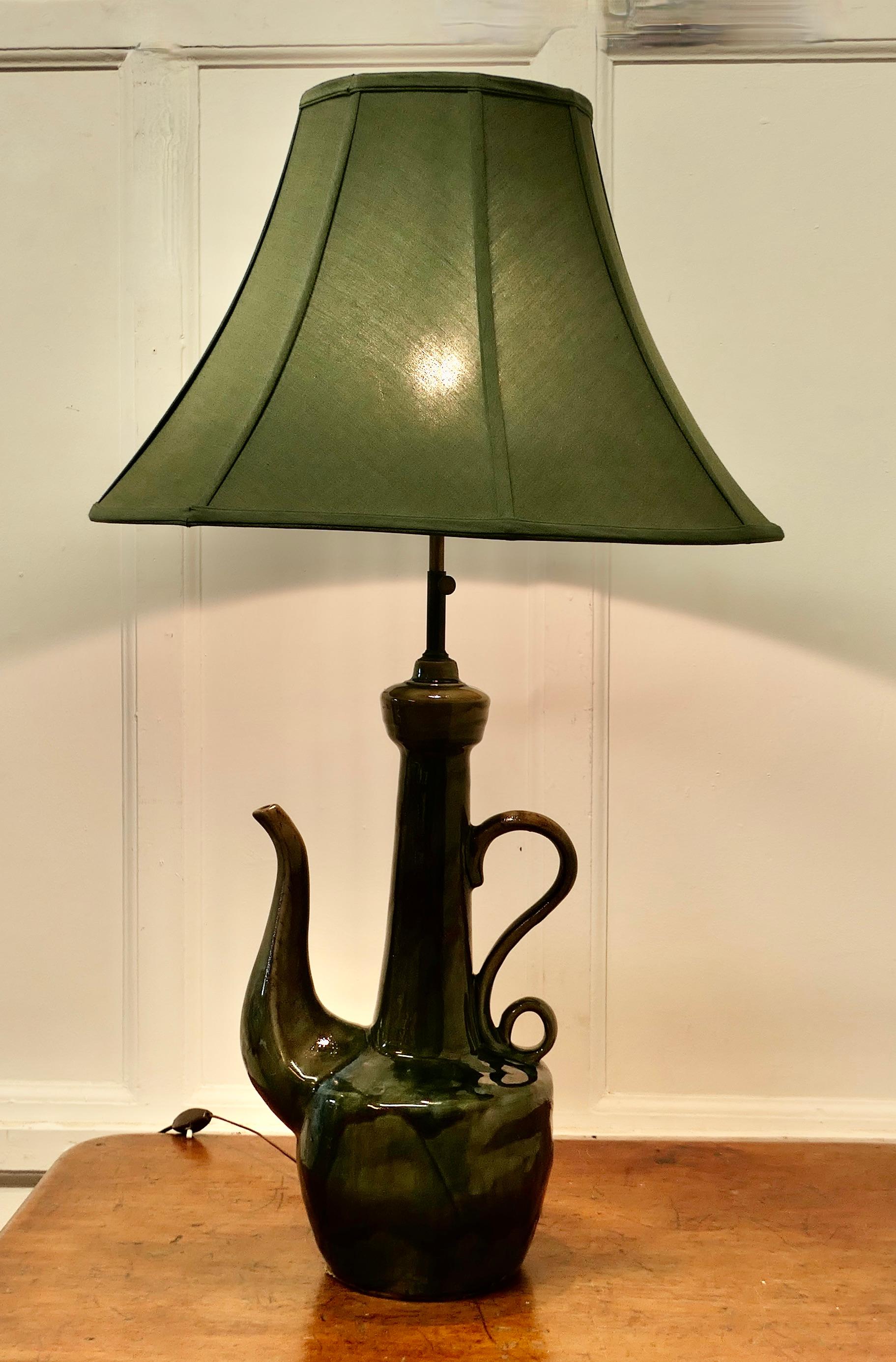 Large Arts and Crafts Quirky Tea Pot Table Lamp
 
Made as a Table Lamp, this quirky piece has an  Art Pottery base, very much in the style of, and possibly by Bretby in green with a majolica glaze
The lamp has a height adjustable central column
The