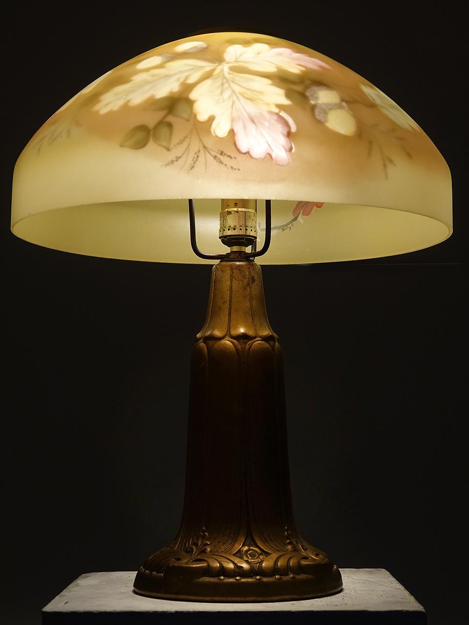 This is the type of lamp that sets the mood in a small room. The lamp is hand painted on a domed amber glass 16 inch diameter shade. It gives a homey warm glow. The size is perfect for a writing desk or side table because of the 20 inch height.