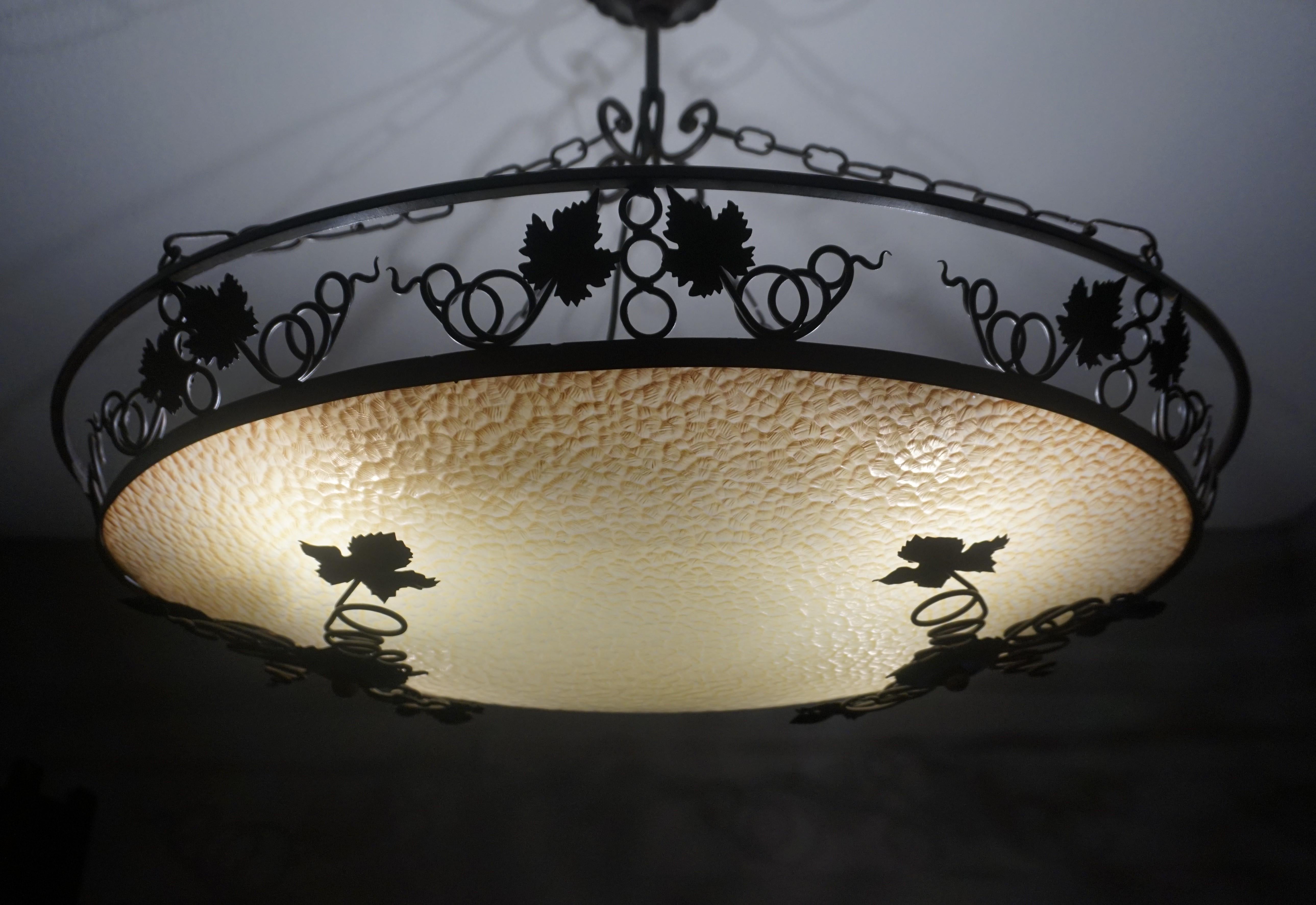 Perfect shape and ideal size chandelier for a dining or kitchen table.

This all handcrafted, four light chandelier from the earliest years of the 20th century has the perfect oval shape and a decor of wine leafs, which makes it the perfect light