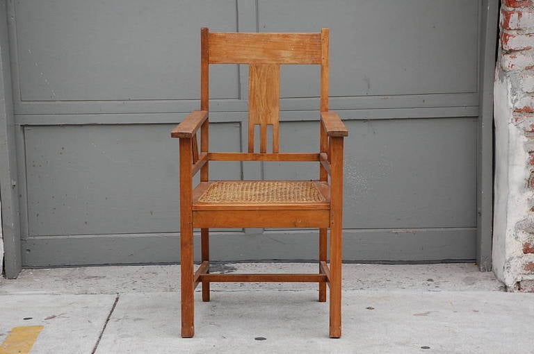 Large Arts & Crafts caned armchair. Measure: Arm height 28 inches.