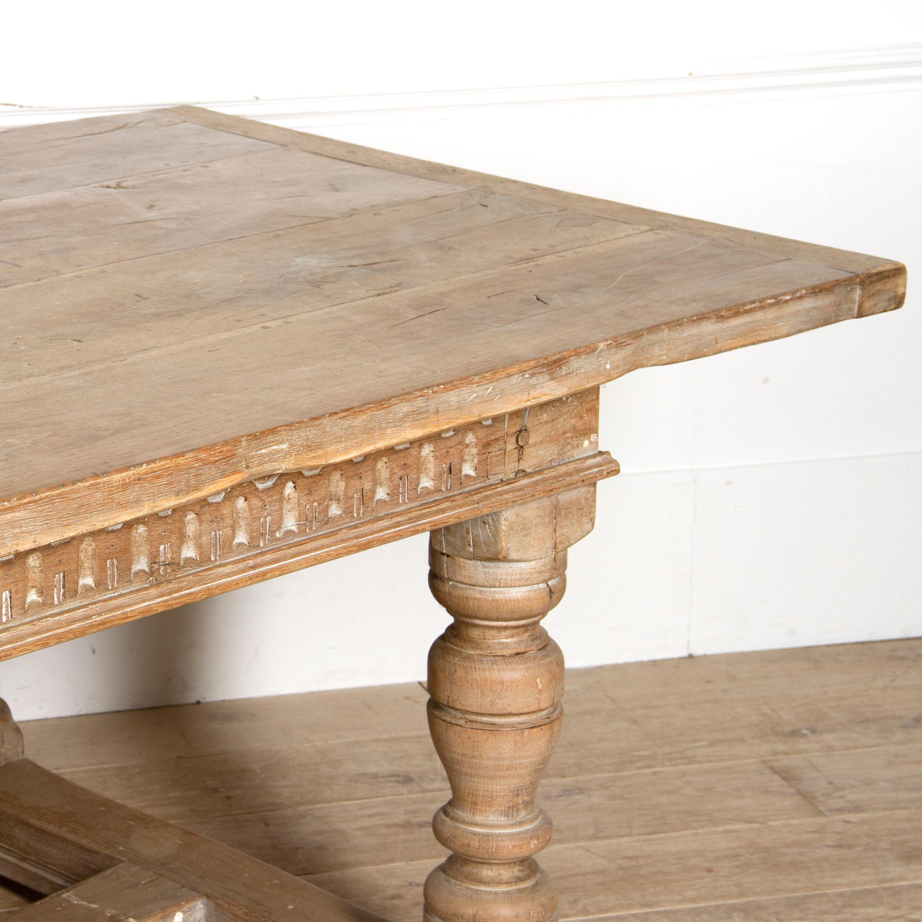 Impressive English 'Arts & Crafts' refectory table. 

This substantial table is comprised of solid oak with turned and baluster legs and stretchers. It also has a heavy peg, dowelled top. 

It has a pleasing and natural 'scrubbed' finish in the