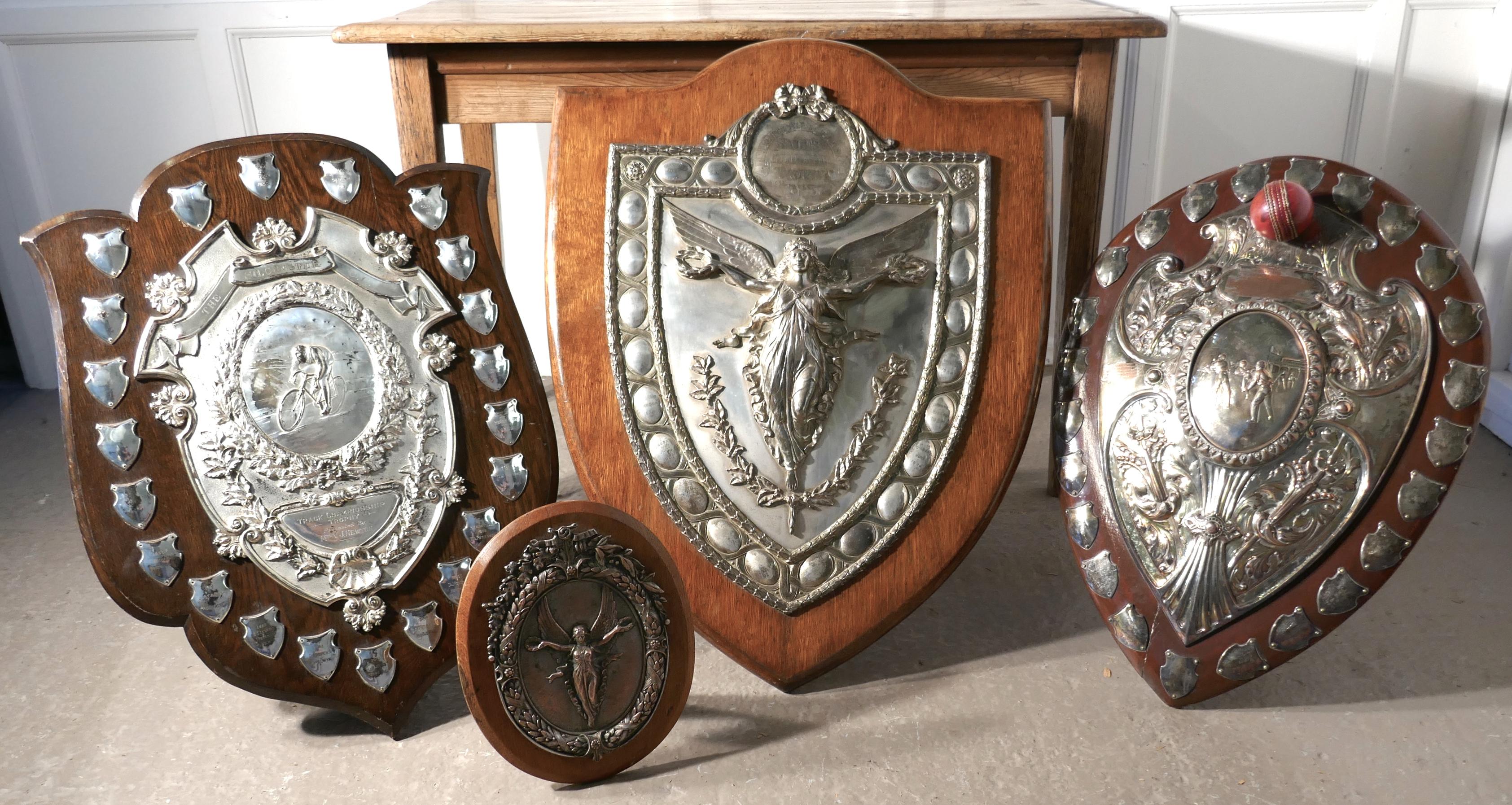 Large Arts & Crafts shield trophy with Nike the goddess of victory 

The is a very impressive Arts & Crafts piece, the golden oak shield has a large silver plated mount, in the centre there Nike the winged Greek goddess of victory celebrating with