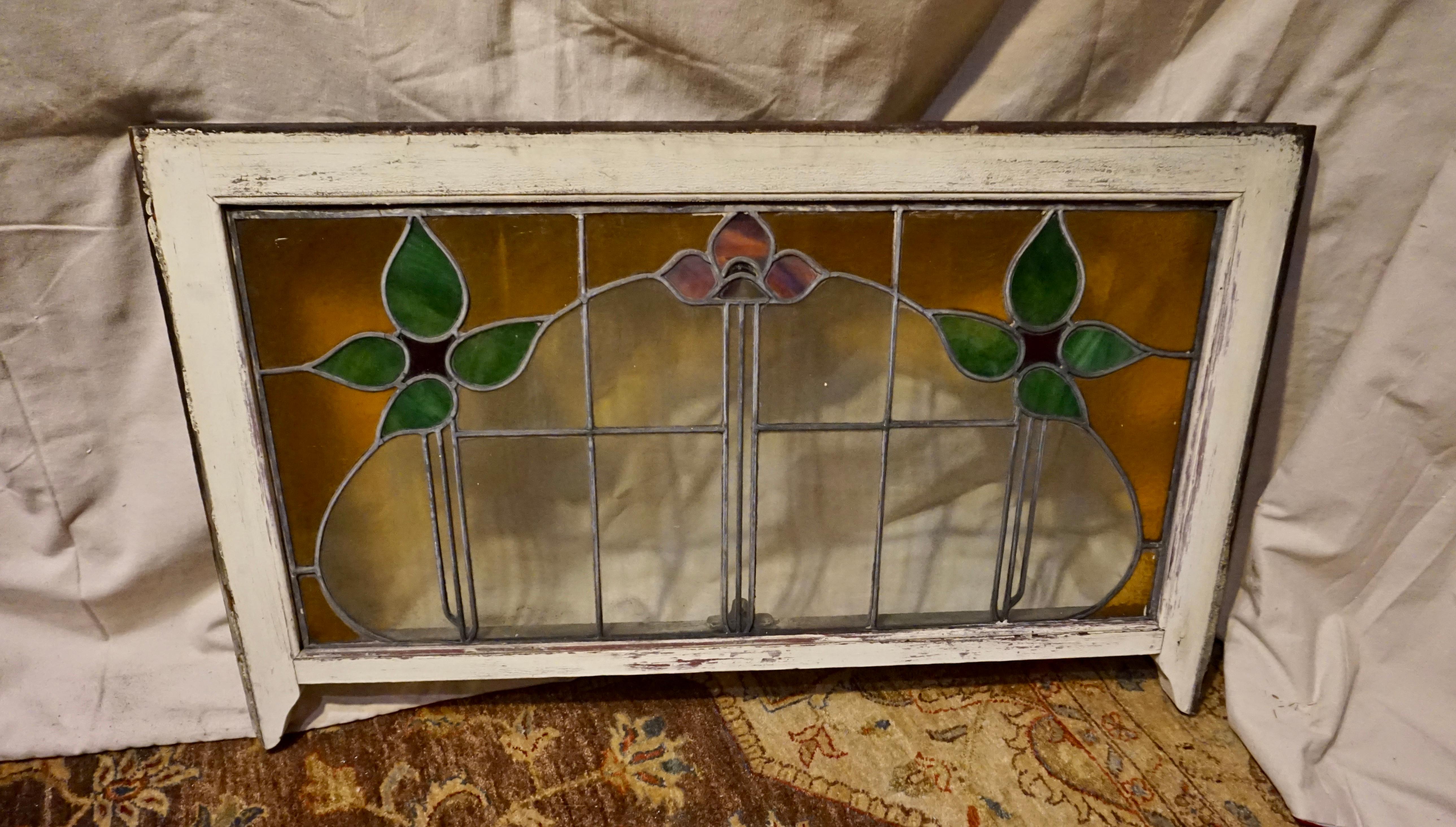 Arts & Crafts Large stained glass window circa 1900-10. Beautiful archway shape highlighted by warm floral motifs. Good original condition. This design is rare to come across and will be magnificent in the right setting.