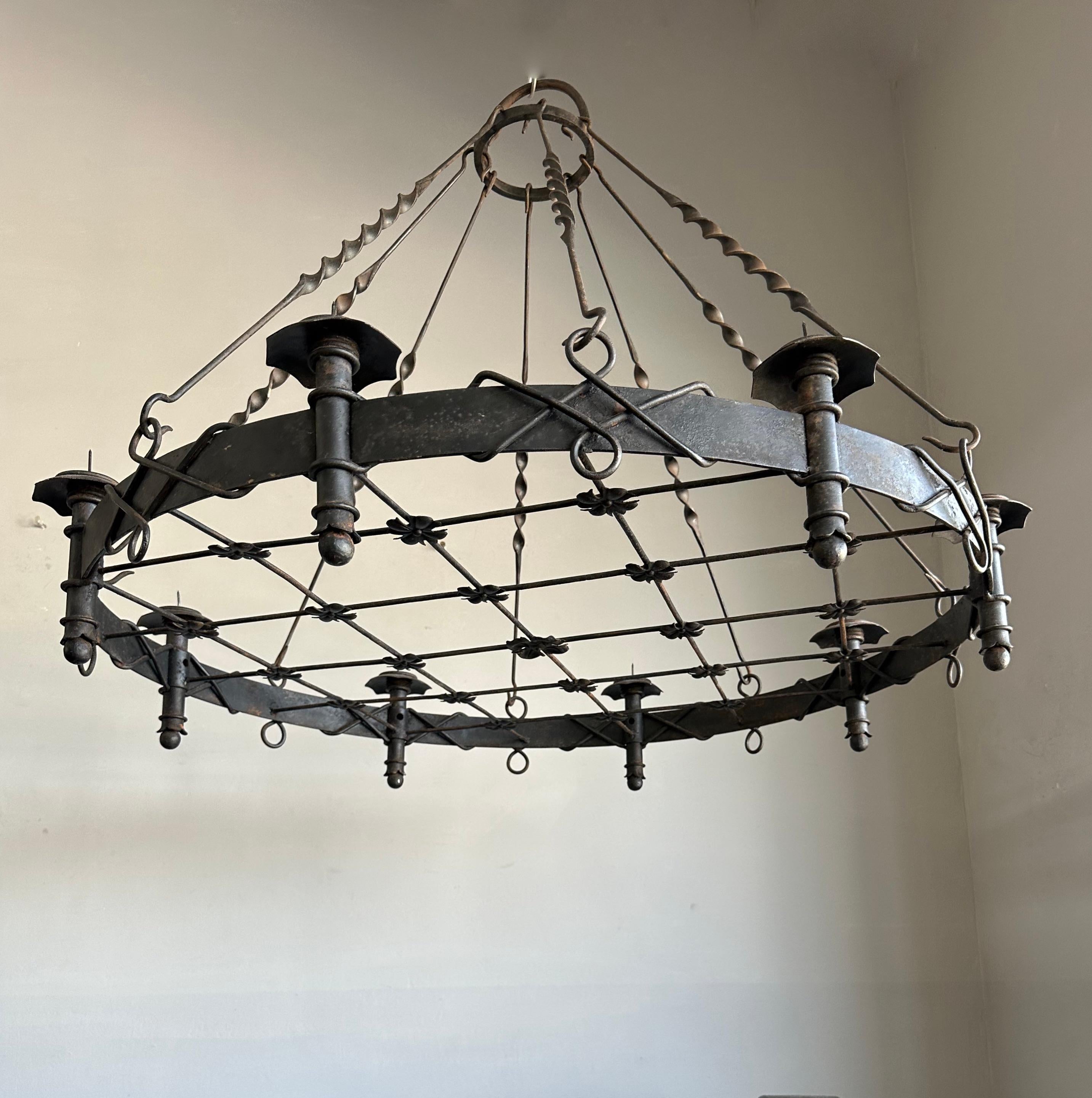 Great quality, forged in fire, castle design candle chandelier / pendant light.

This finer quality and all hand-forged, eight-light chandelier comes with some really beautiful details (including the stunning, turned metal rod-chain) that certainly
