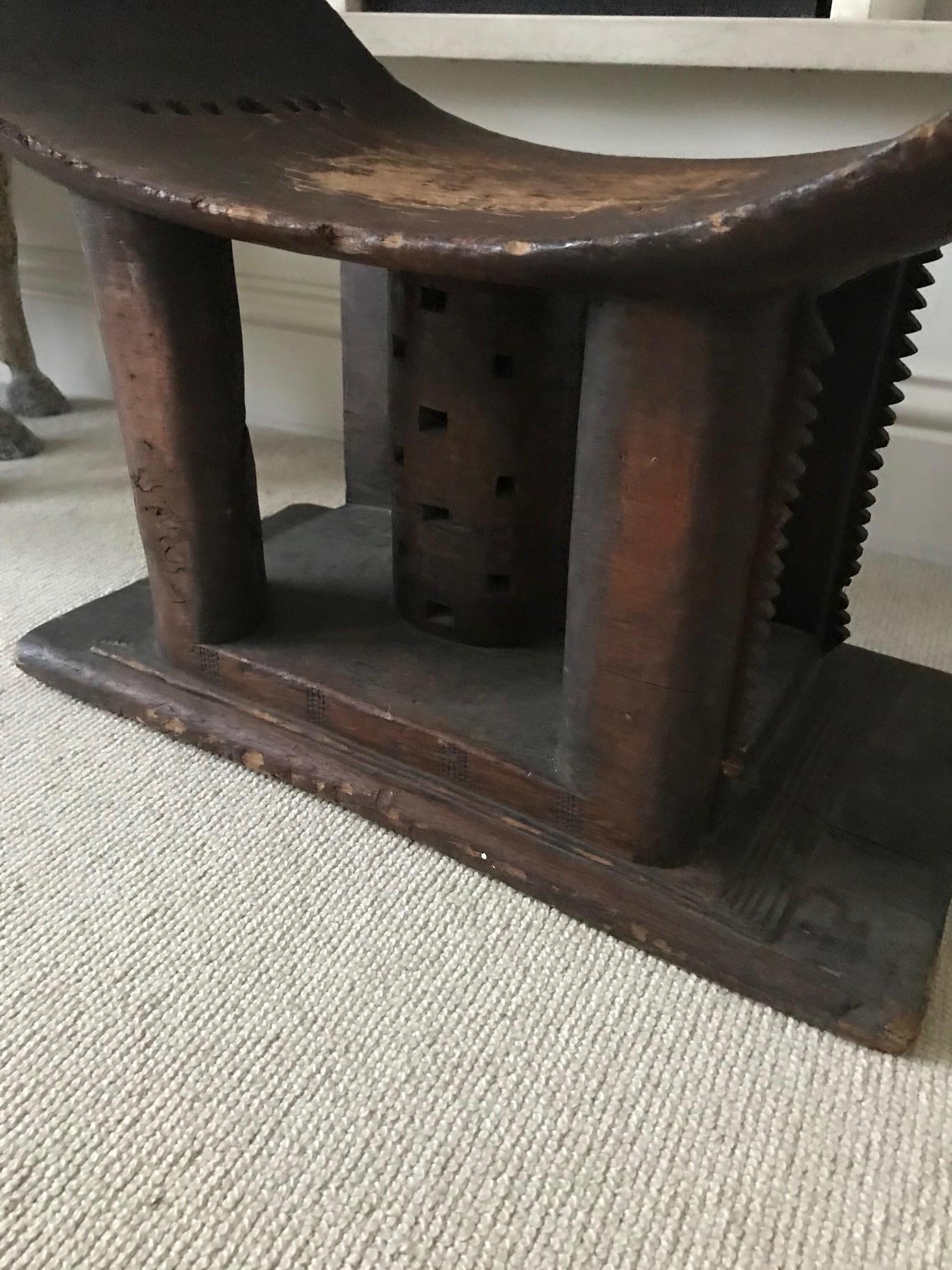 A large Ashanti stool from Ghana. Larger than average with good patination, signs of wear and tear and fine carving. Carved from one single piece of wood.