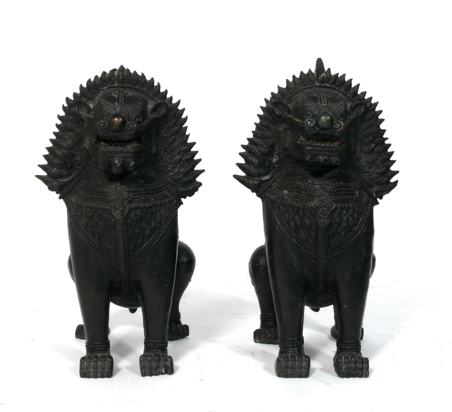 Pair of Large Asian Bronze Foo Dogs or Kylin Dragon, probably Chinese, circa 1950s or earlier. They retain their warm original patina. These were purchased from the Manhattan estate of a Japanese American that traveled extensively through Asia in