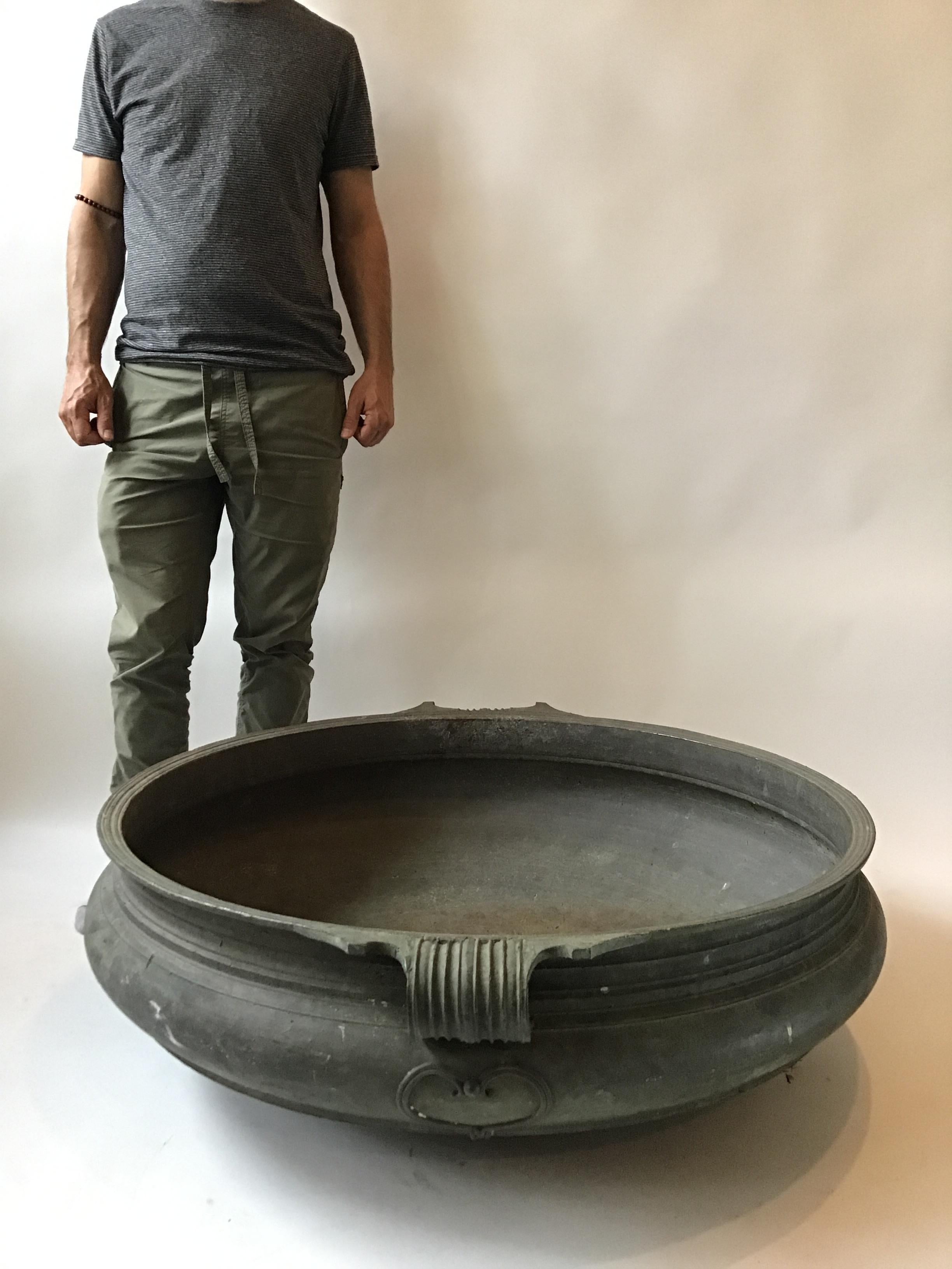 Large Asian Indian cast bronze Urli Temple bowl. This dish was a traditional container used for serving food in temples. Great now as a planter or centerpiece on a table. Cracks in bowl as seen in image 5 and 6.