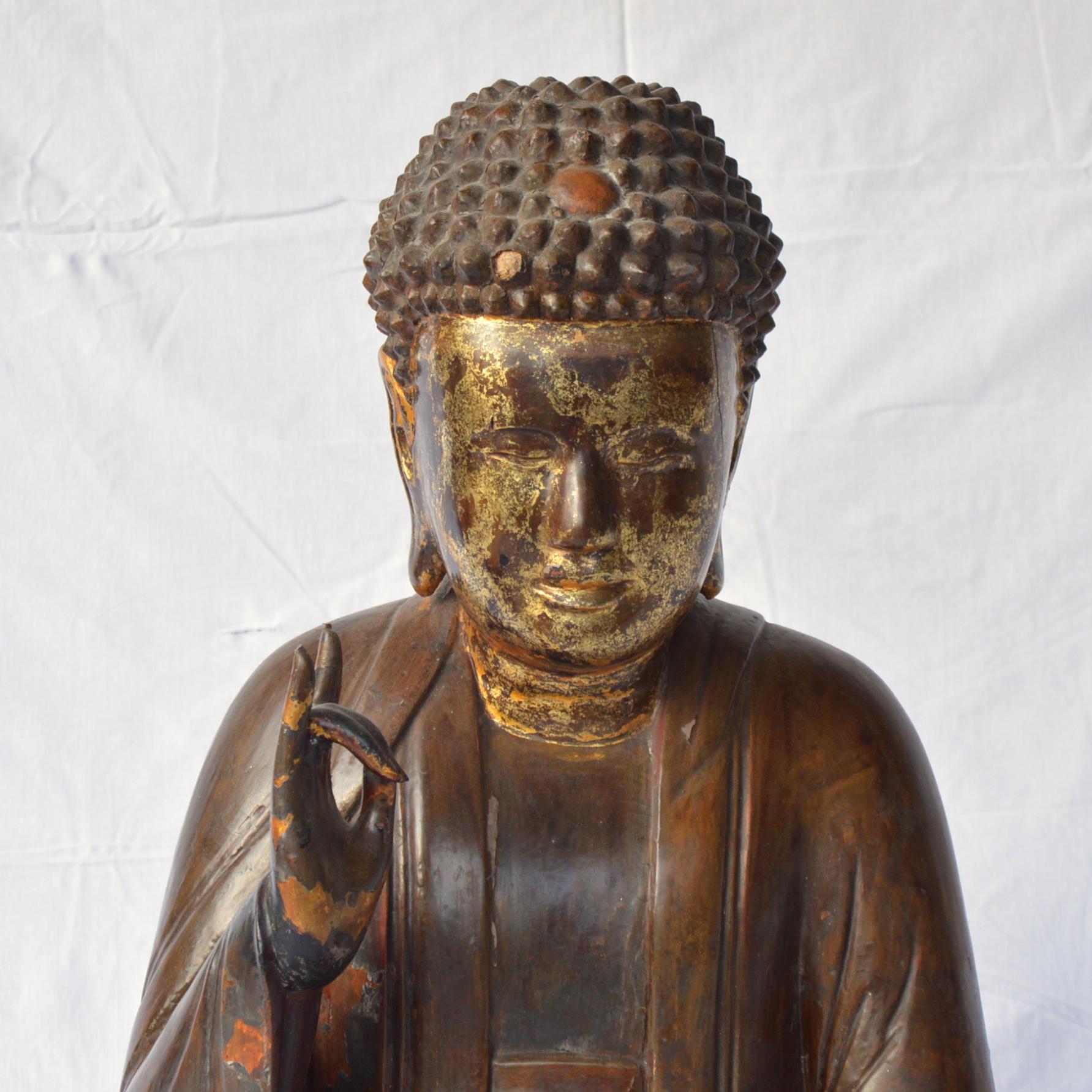 Large Asian patinated and gilt Buddha sculpture.