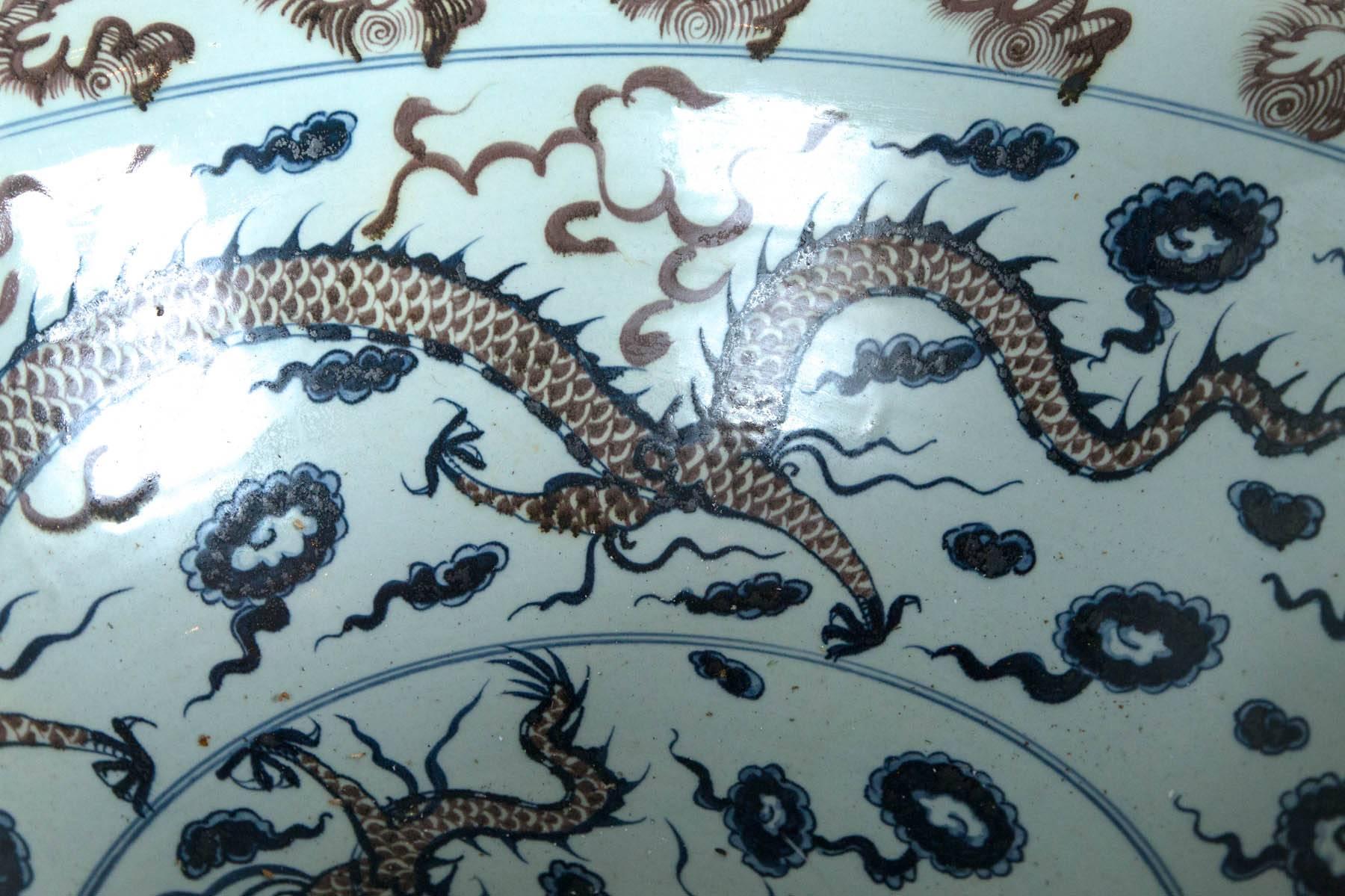 White ground with blue and red decoration of dragons, flames and clouds.