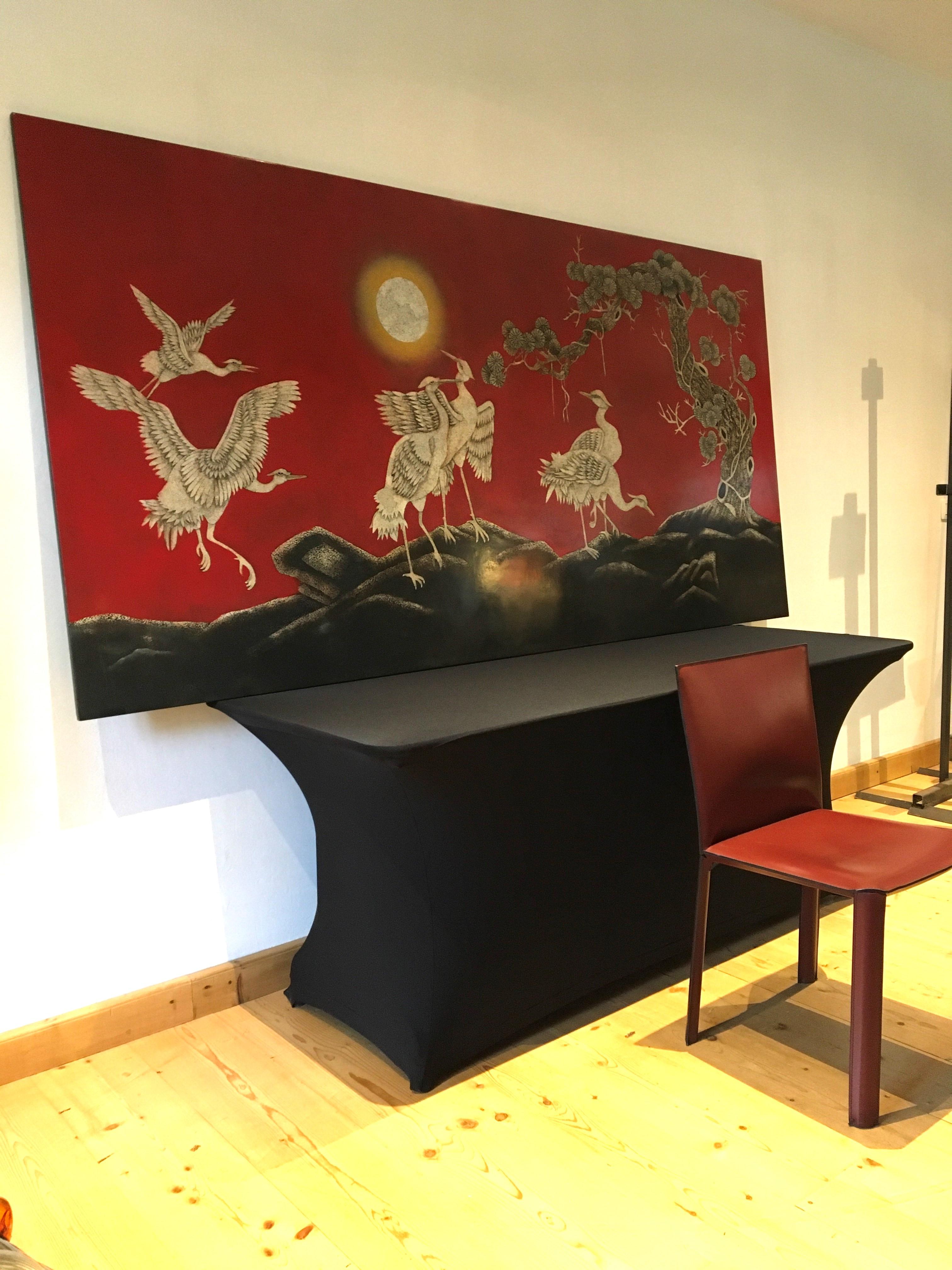 Stunning large Asian wall panel with cranes. This red art panel shows a beautiful landscape with 6 crane birds, the sun and an asian tree. It's stunning by his color and by size : 96,06 inch or 244 cm long ! 
It's a red wooden panel with black