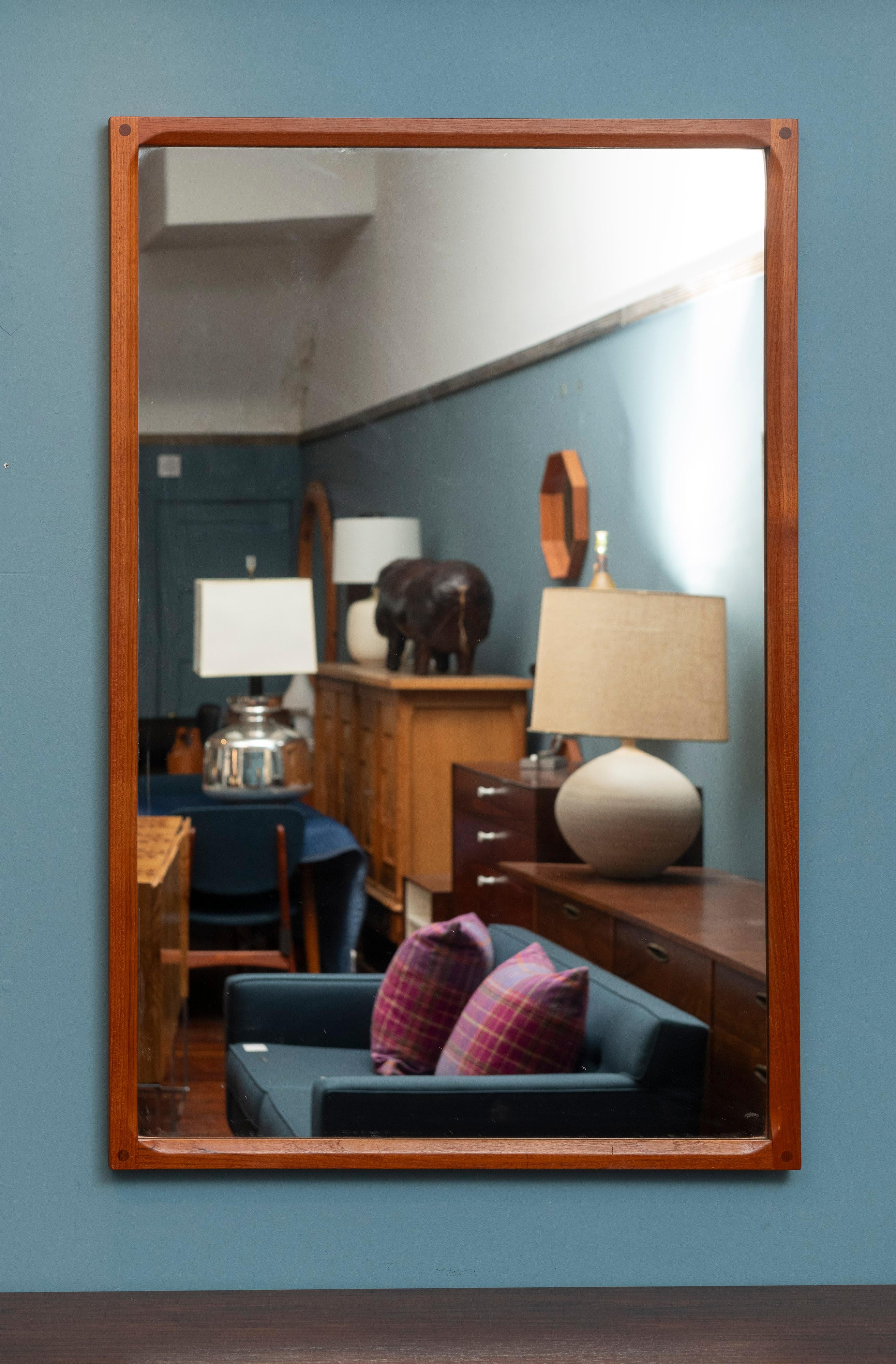 Large Askel Kjersgaard teak wall mirror for Odder, Denmark. High quality construction and materials made from solid teak with dowels at the corners. This is the rare large size at almost 4'ft. high by 31
