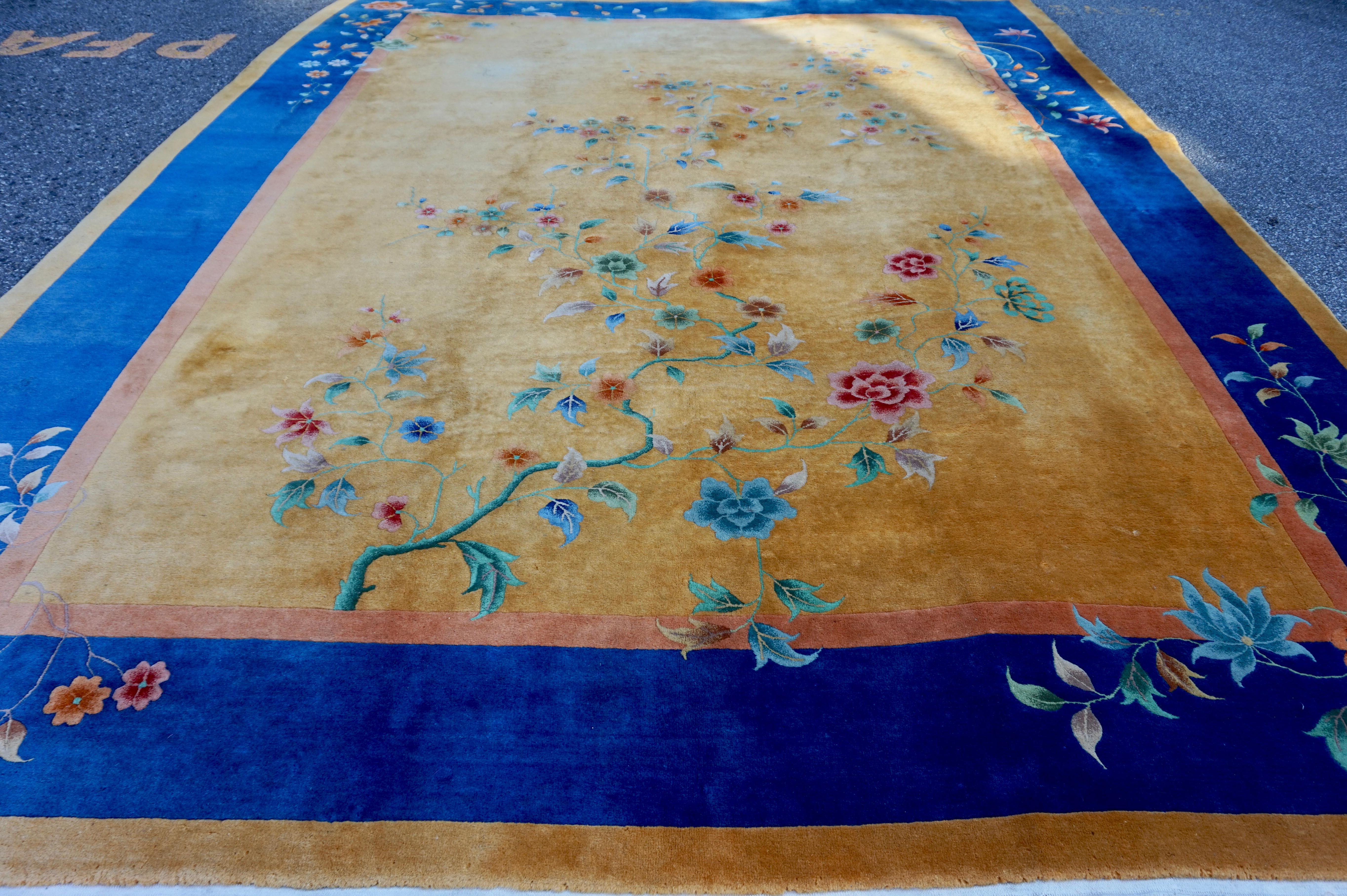 Circa 1930's

Warm ochre hues in luxurious wool contrasted against royal blues and an asymmetrical floral theme. Excellent overall pile condition with minor age and use spots as shown in photos. Beautiful Art Deco rug.
 