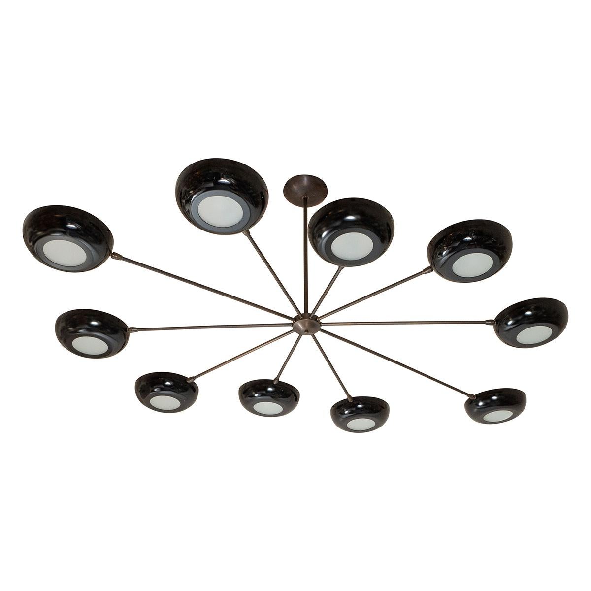 Ten-arm chandelier in antique brass and semi gloss satin black shades. Frosted glass fittings at the bottom of each standard base. It can be ordered in multiples and customized with different finishes and colors. Max 100 Watts per socket.