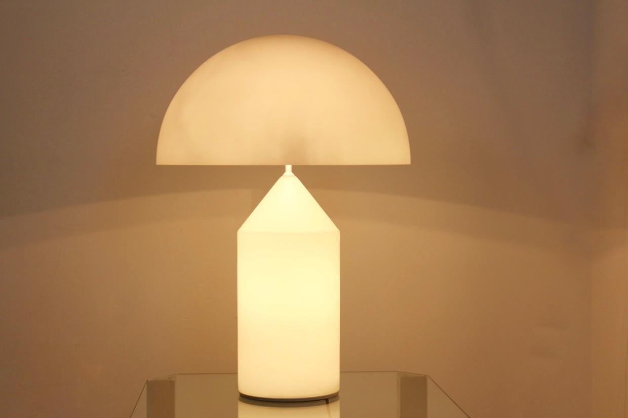 Italian adjustable white glass Atollo lamp designed by Vico Magistretti for Oluce. Produced during the 1960s and in very good original condition. Stunning and old model from 1969 by Oluce, entirely crystal made. Uniqueness due to its adjustable