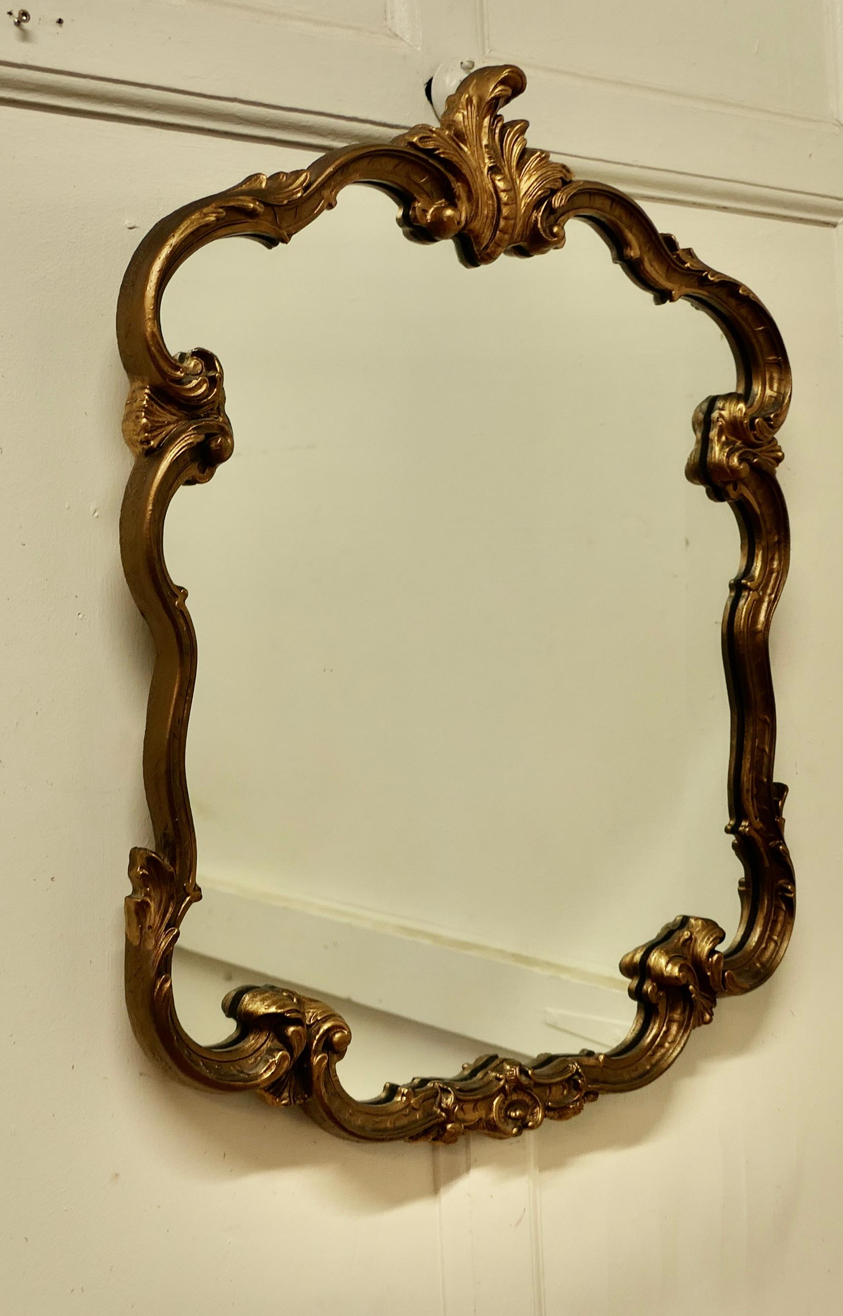 Large Atsonea Rococo style gilt wall mirror

The Mirror has a decorative Rococo gilt frame set with acanthus leaves in an unusual shape to surround the glass mirror
The mirror glass is original and in good condition with little or no foxing