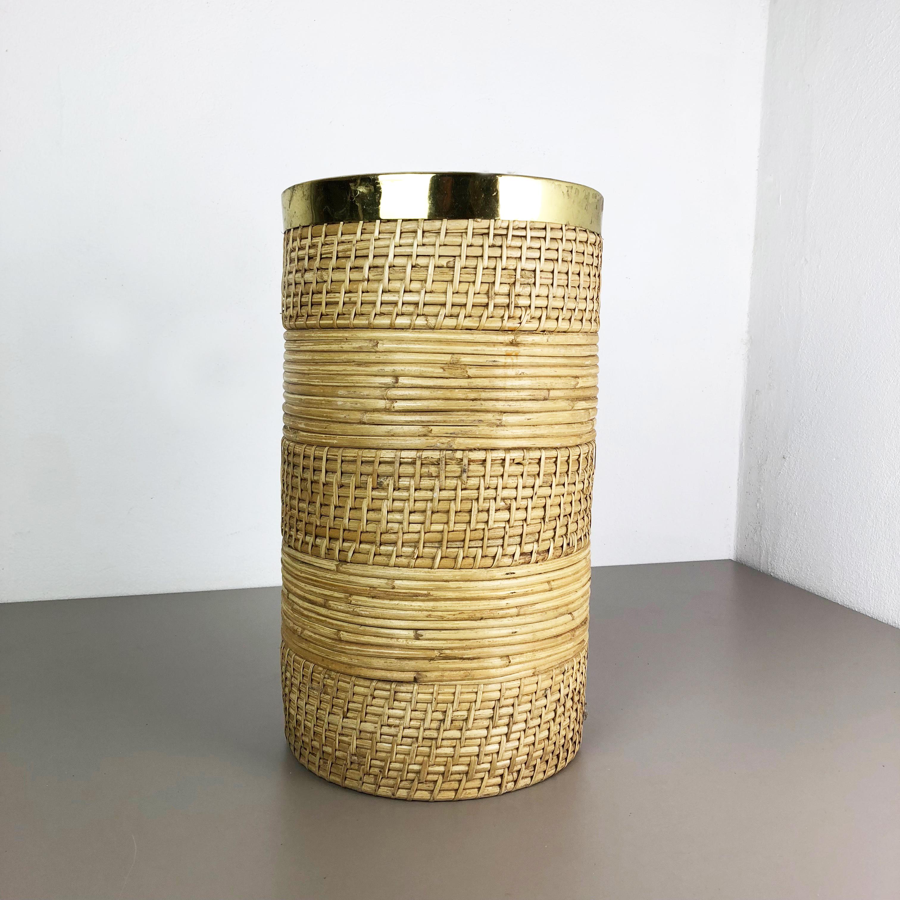 Article: Waste bin paper bin or umbrella stand

Origin: France

Age: 1960s

This original vintage Bauhaus style waste bin paper bin, umbrella stand was produced in the 1960s in France. It is made of natural rattan with a brass applications at the
