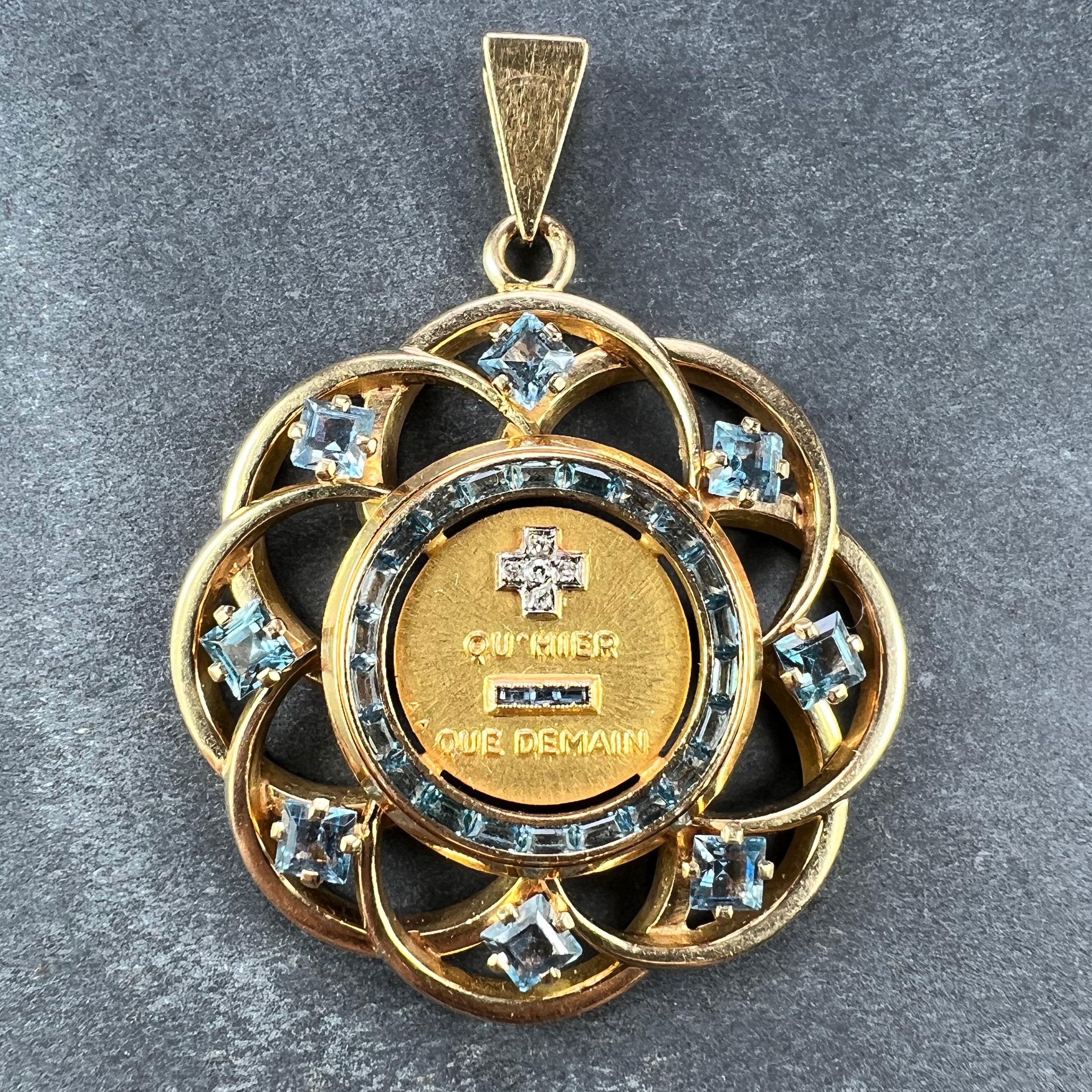 A French 18 karat (18K) yellow gold and lab created blue spinel love charm pendant with a rebus spelling out 