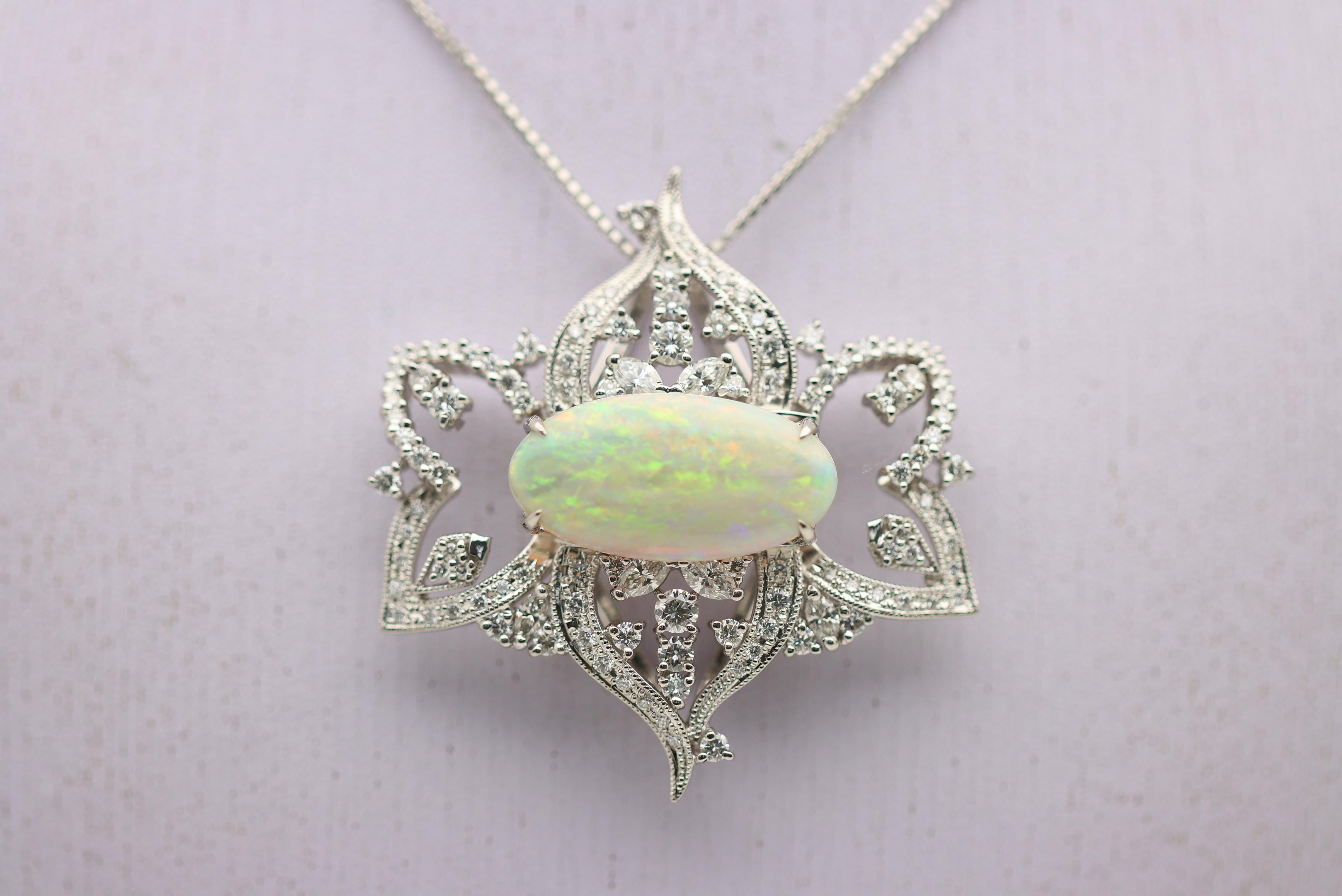 A large and impressive pendant featuring a 6.70 carat Australian opal with excellent play-of-color. The opal displays a wide range of colors which include red, orange, green, yellow and blue, which all dance across the stone as it is moved in the